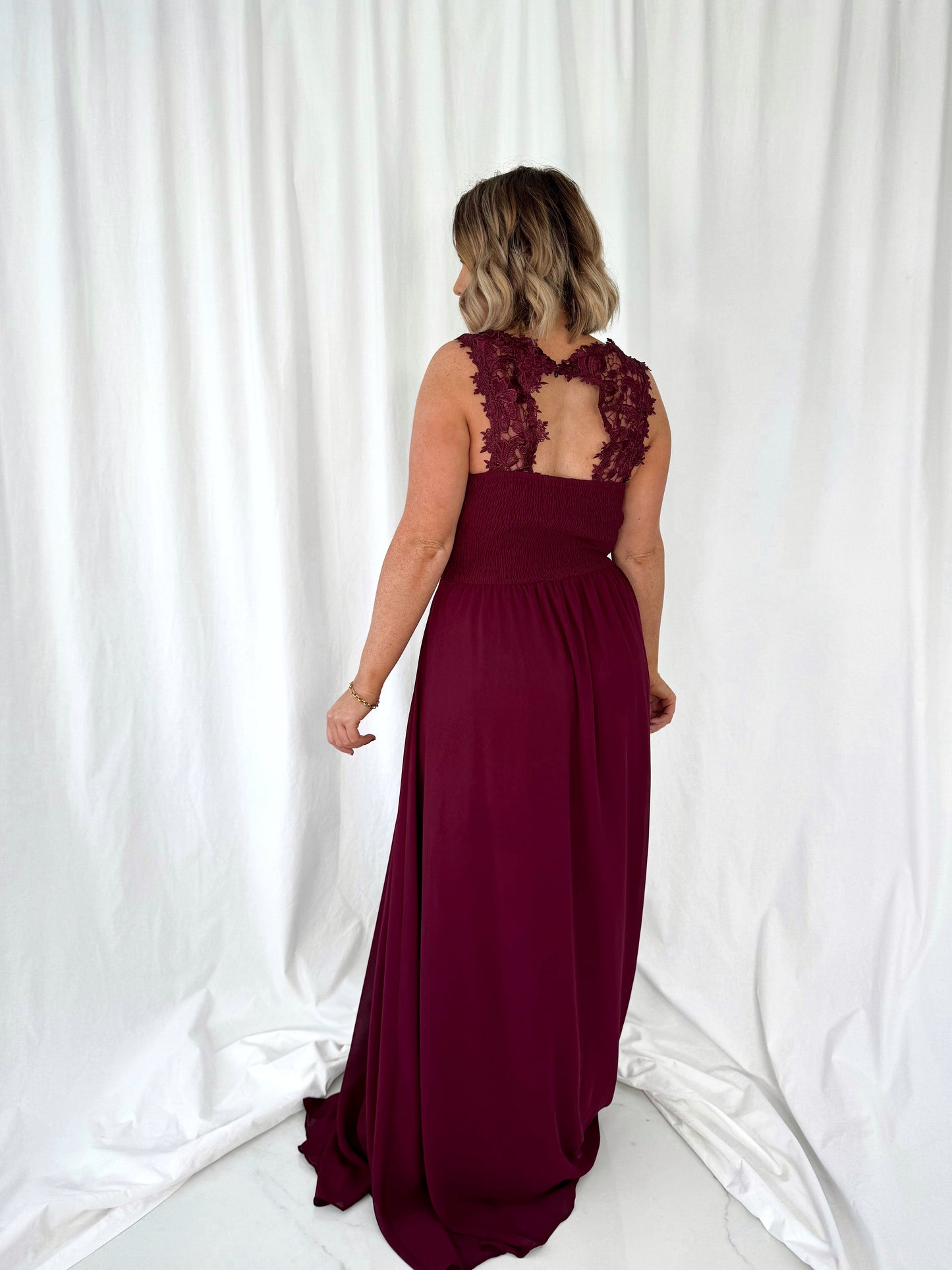 a woman in a red dress standing in a white dress