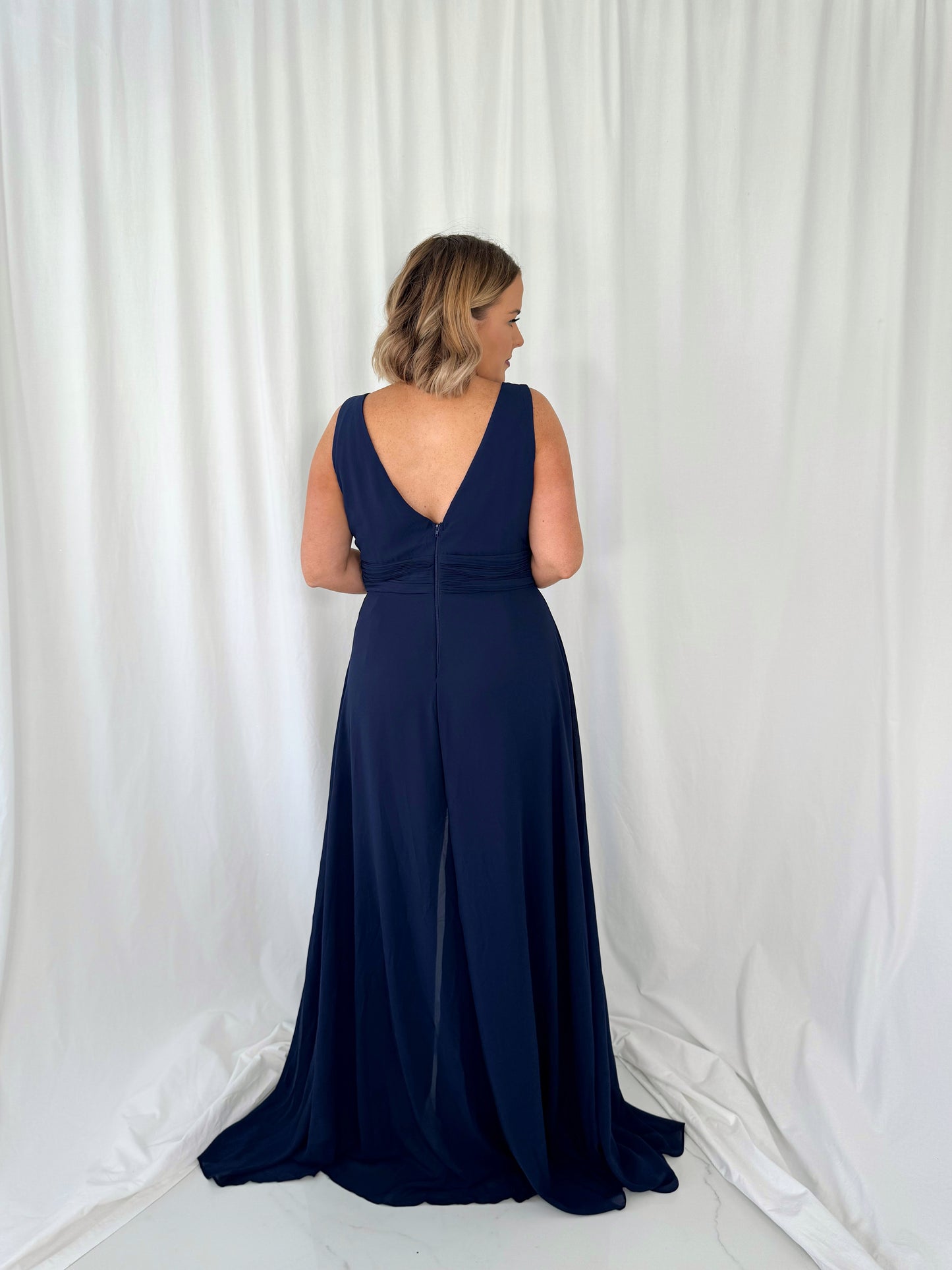 a woman in a dress is talking on a cell phone