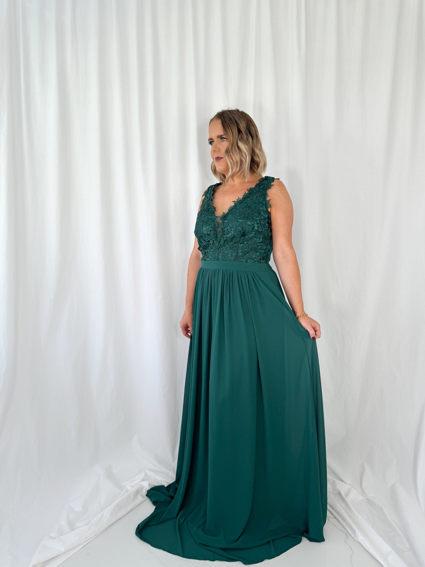 a woman in a dress talking on a cell phone