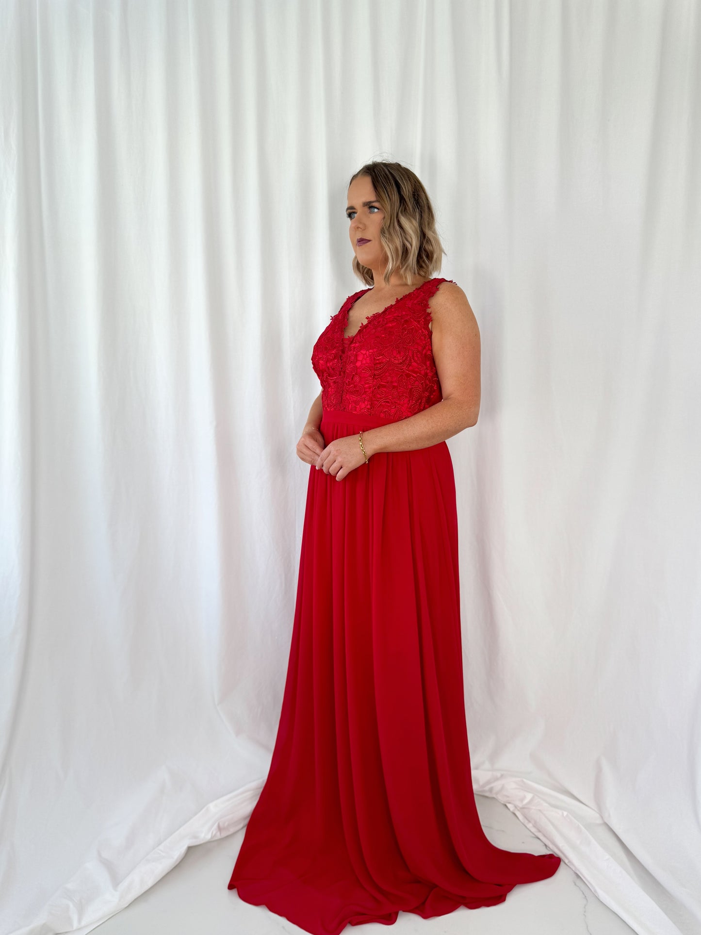 a woman in a red dress holding a red umbrella