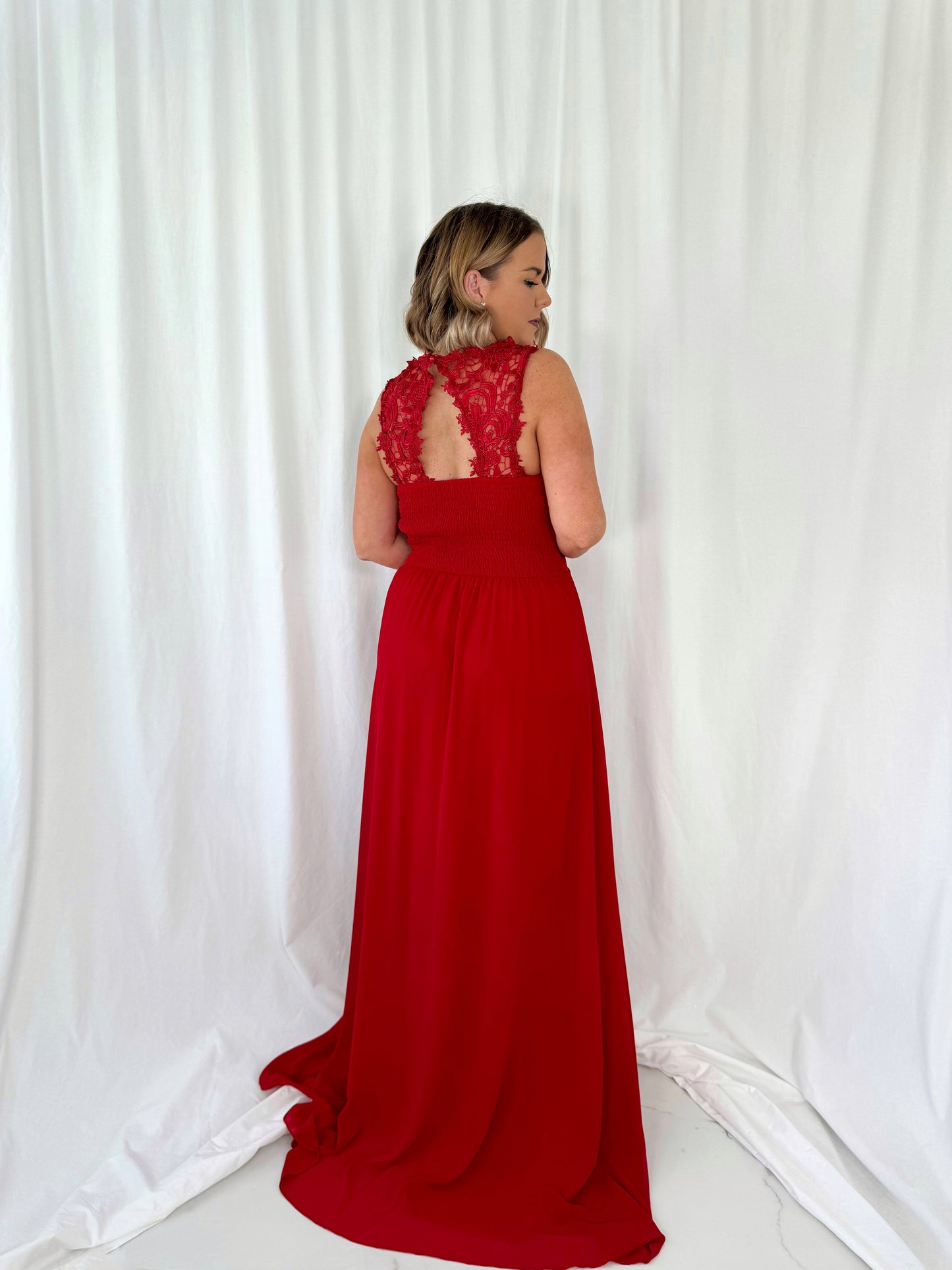 a woman in a red dress in a white dress