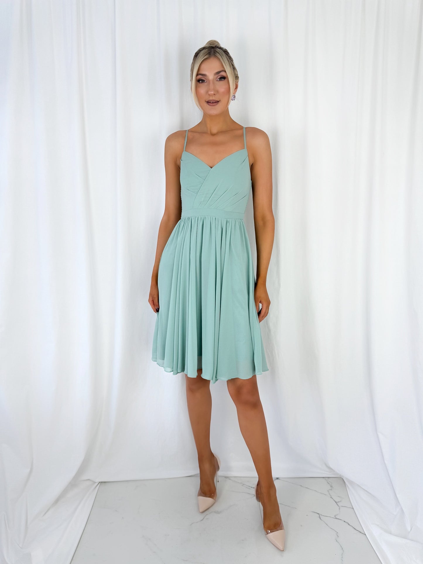 a woman in a dress standing in a white dress