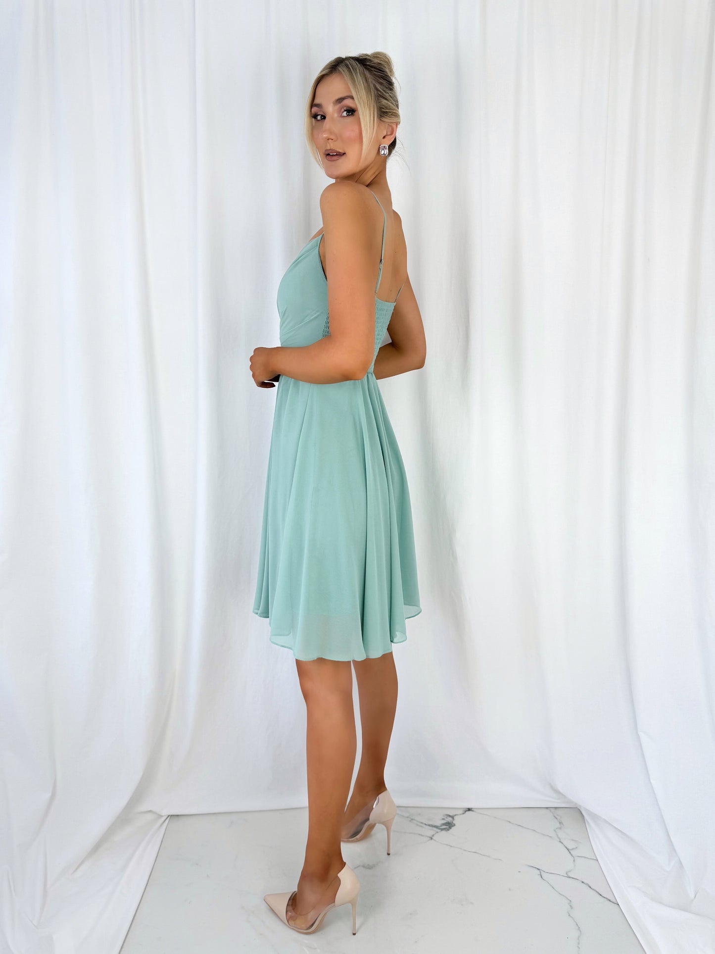 a woman in a dress holding a cell phone