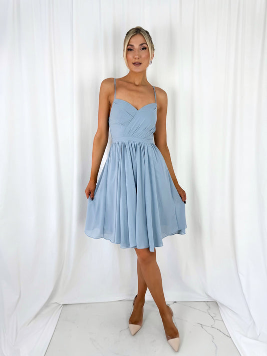 a woman in a dress standing in a white dress