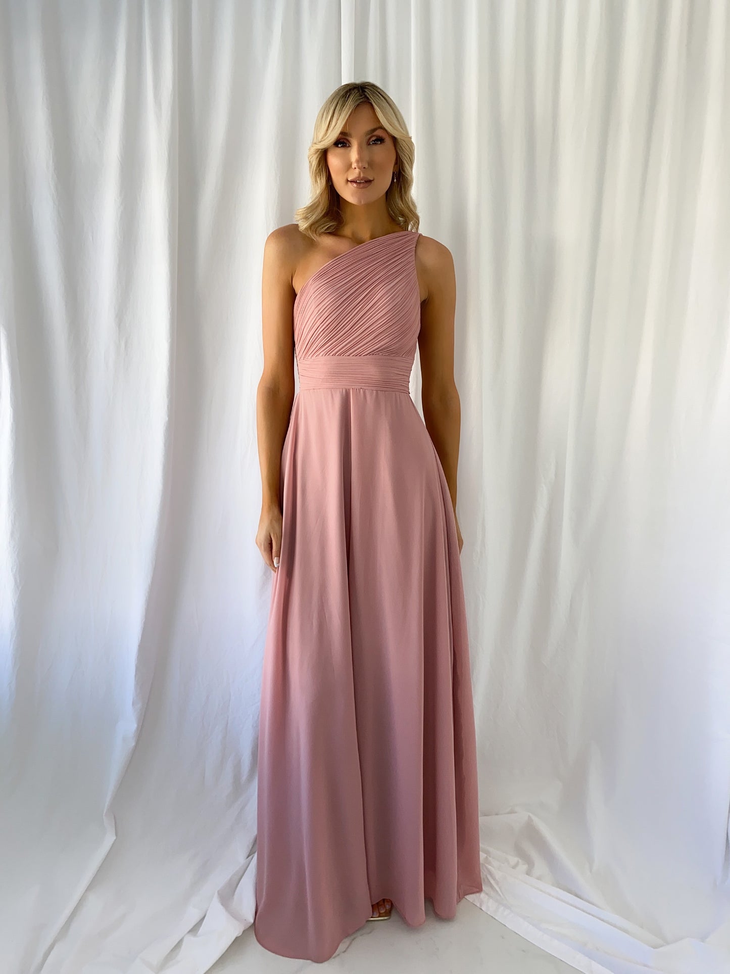 a woman in a pink dress in a white dress
