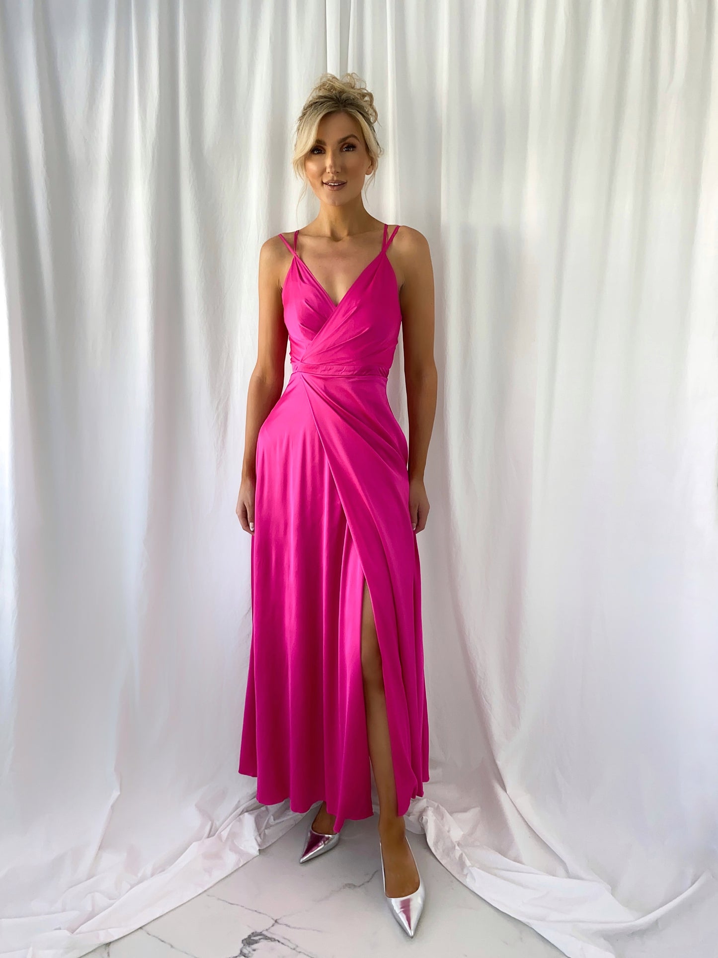 a woman in a pink dress holding a pink umbrella