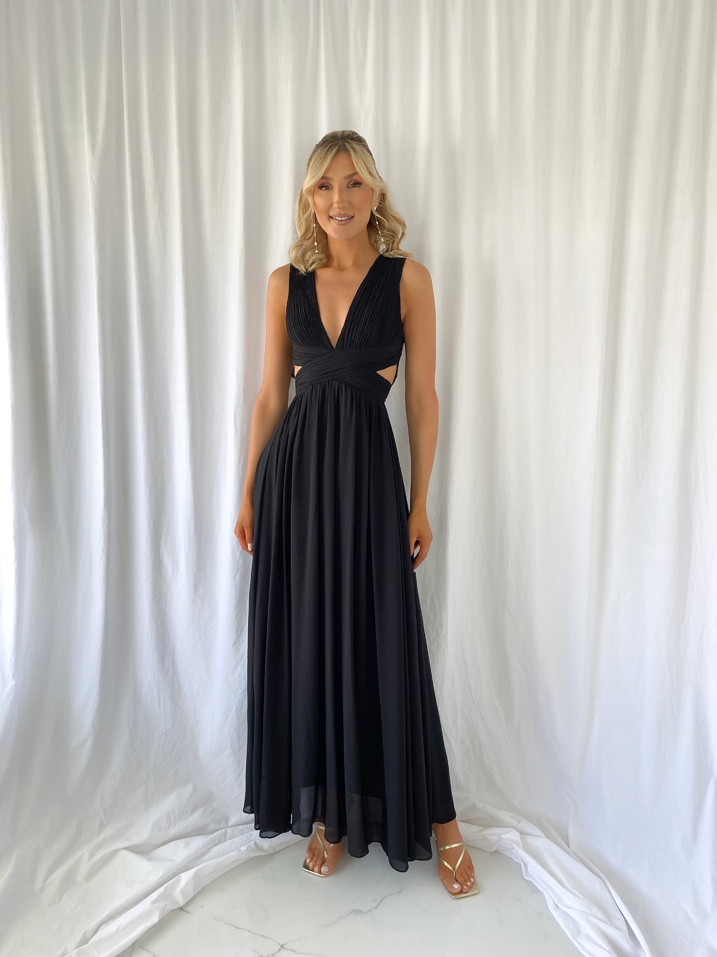 a woman in a dress talking on a cell phone
