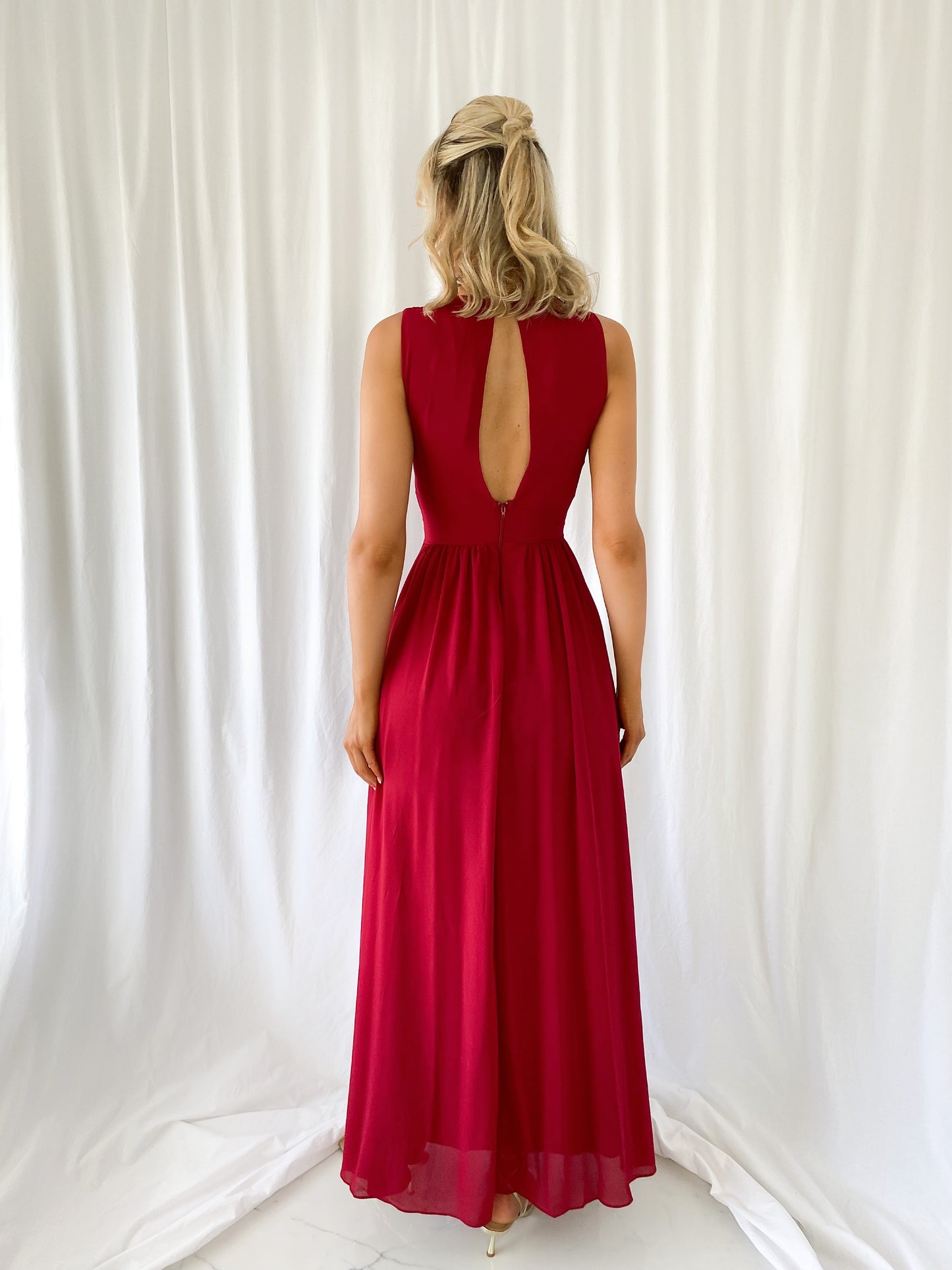 a woman in a red dress in a white dress