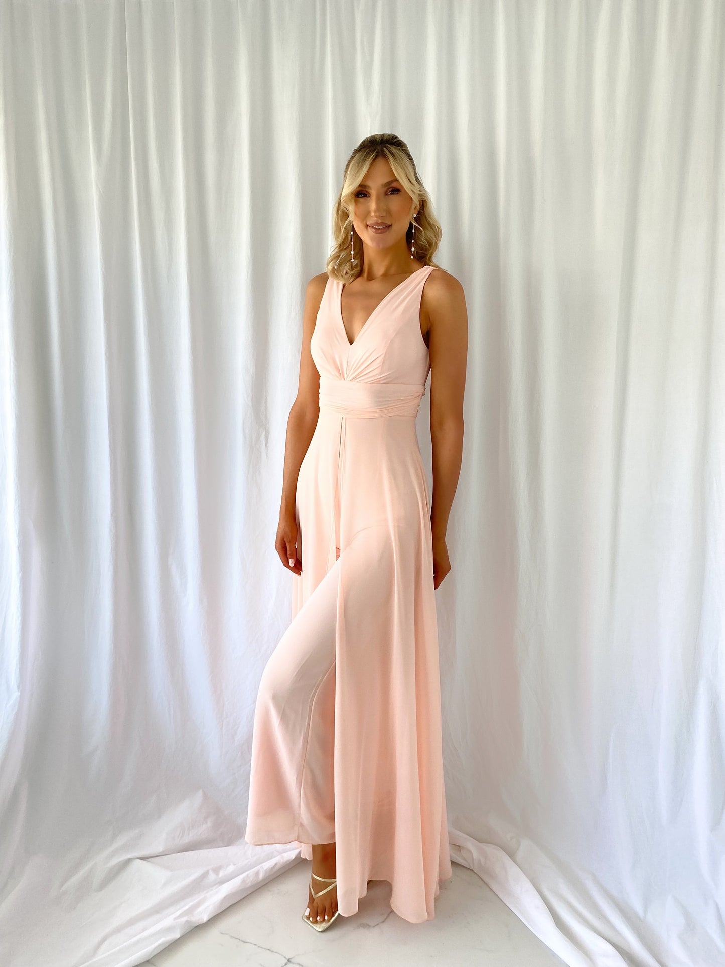 a woman in a white dress standing in a white dress