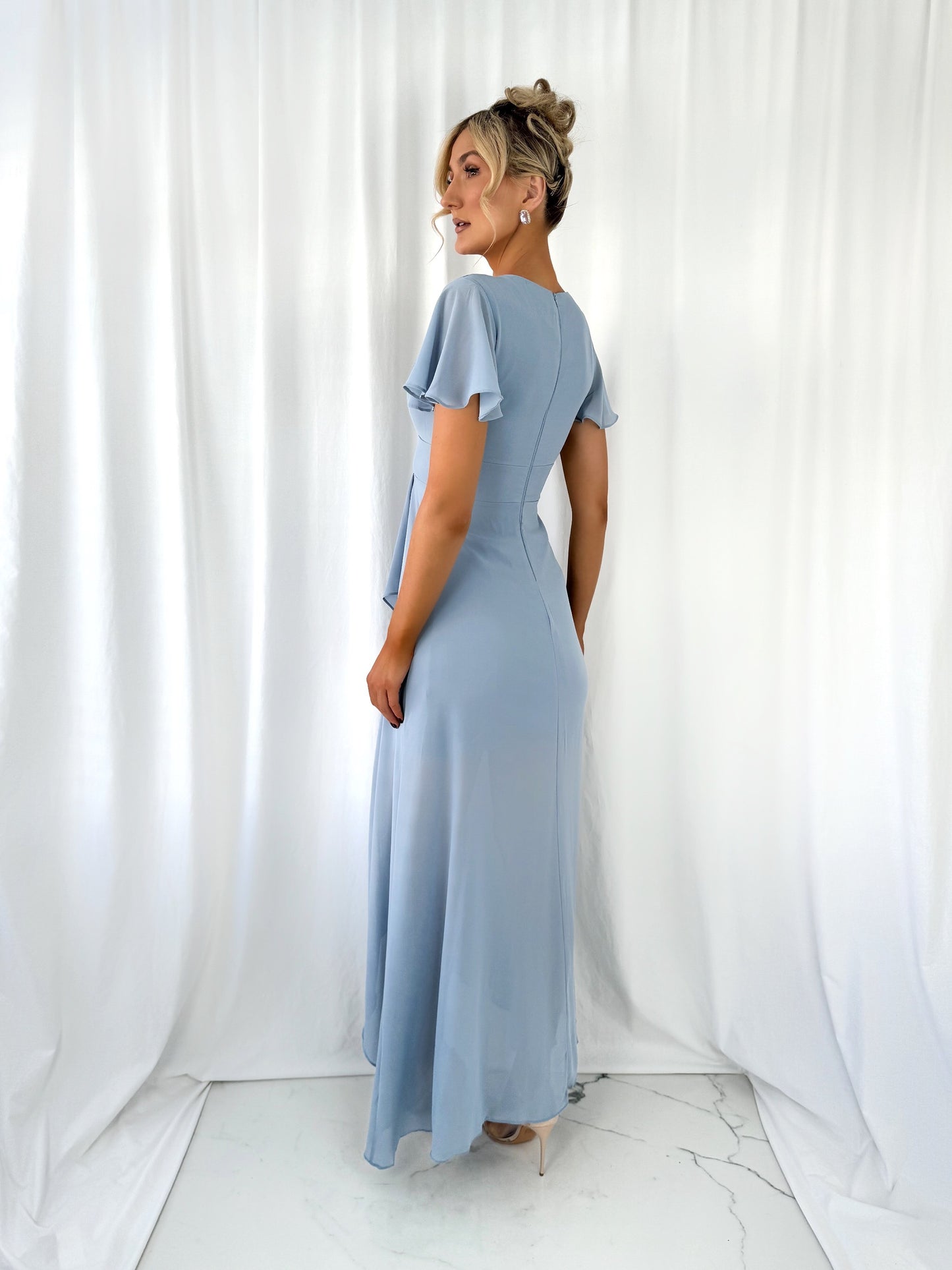 a young woman is standing in a room