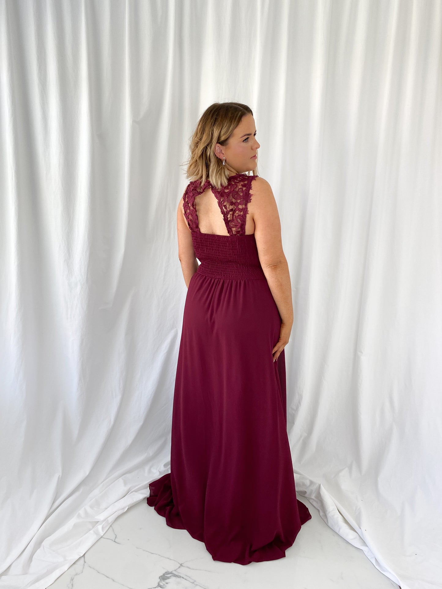 a woman in a red dress talking on a cell phone