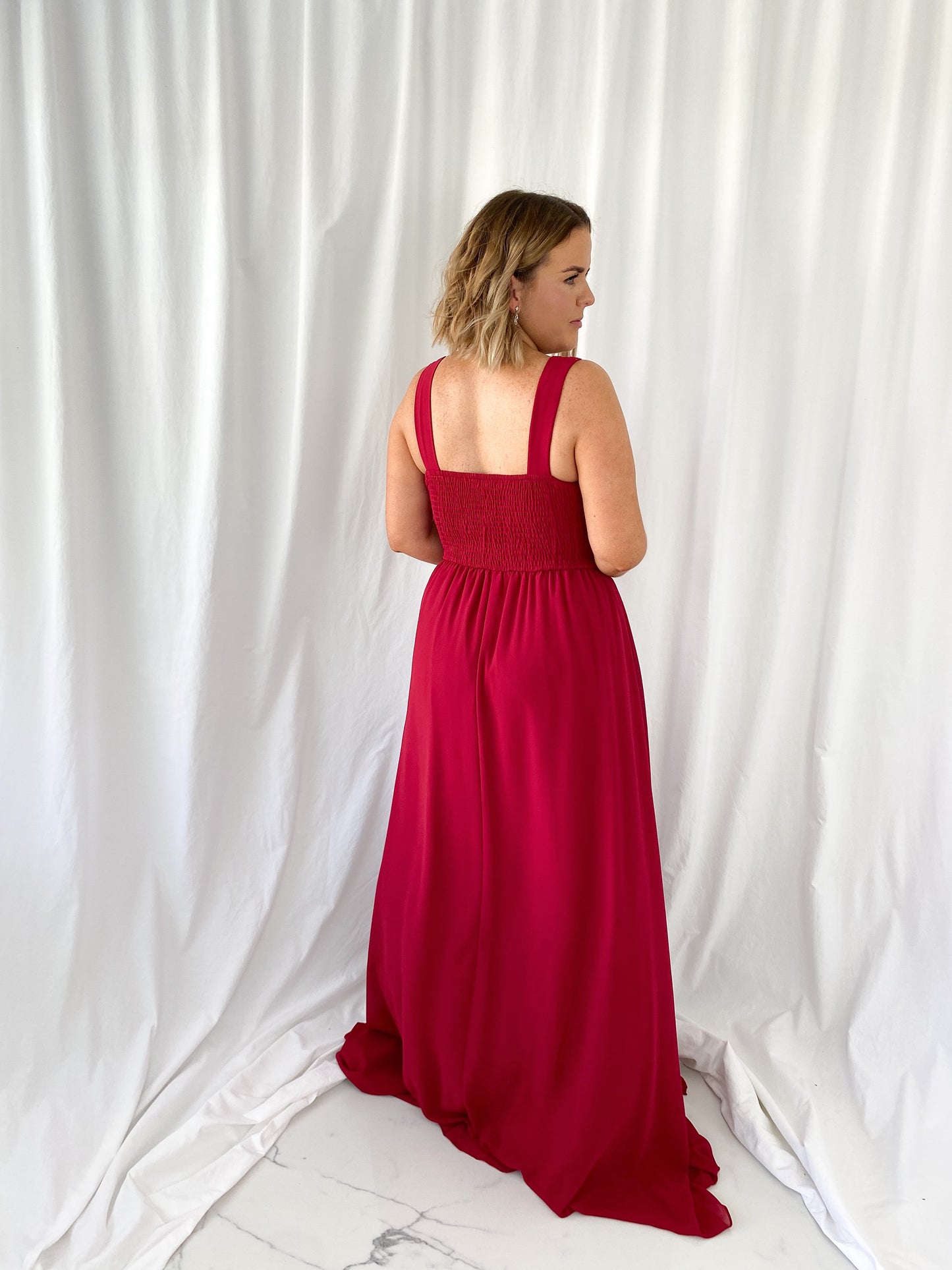 a woman in a red dress in a white dress