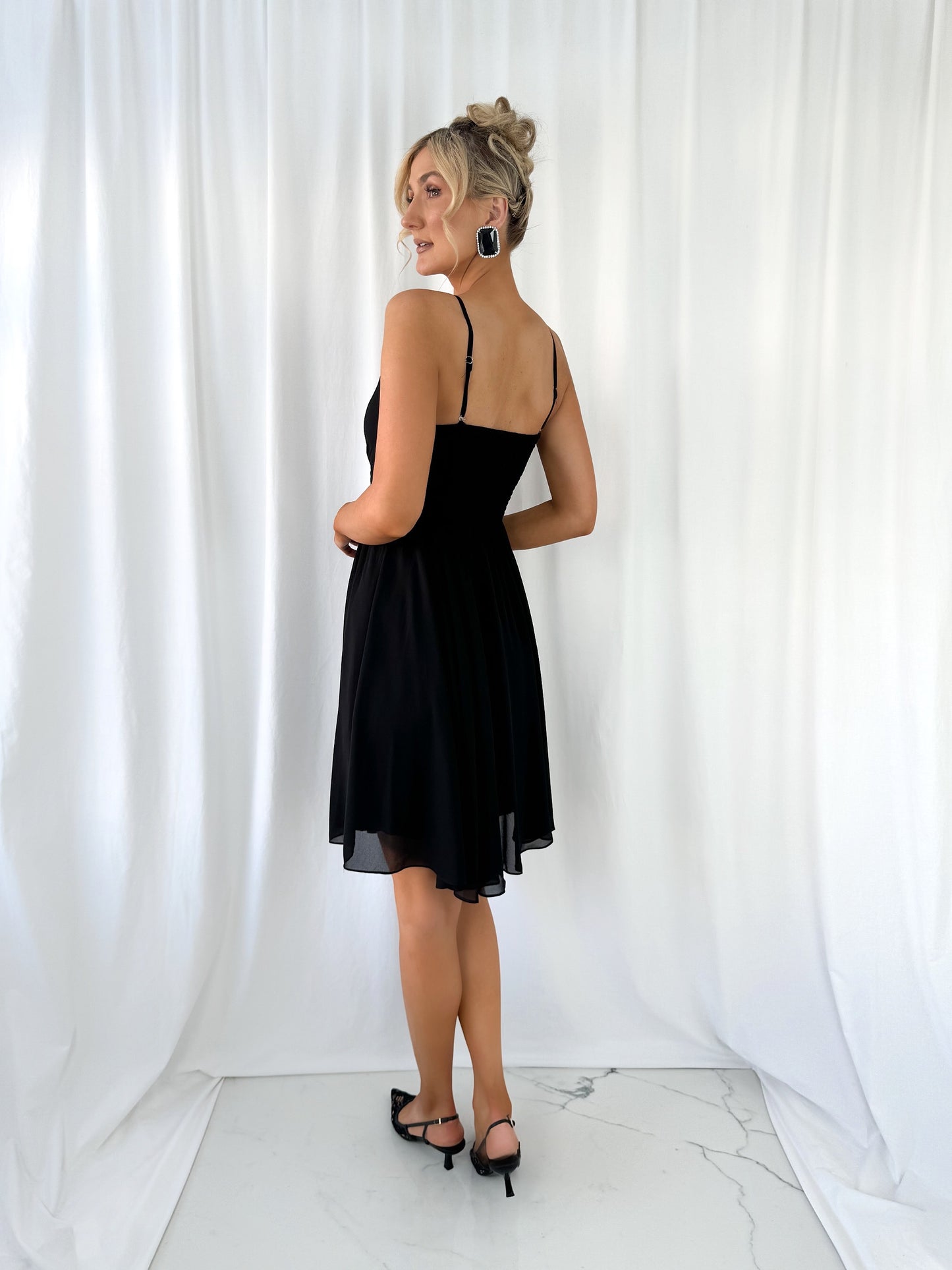 a woman in a dress standing in a white dress