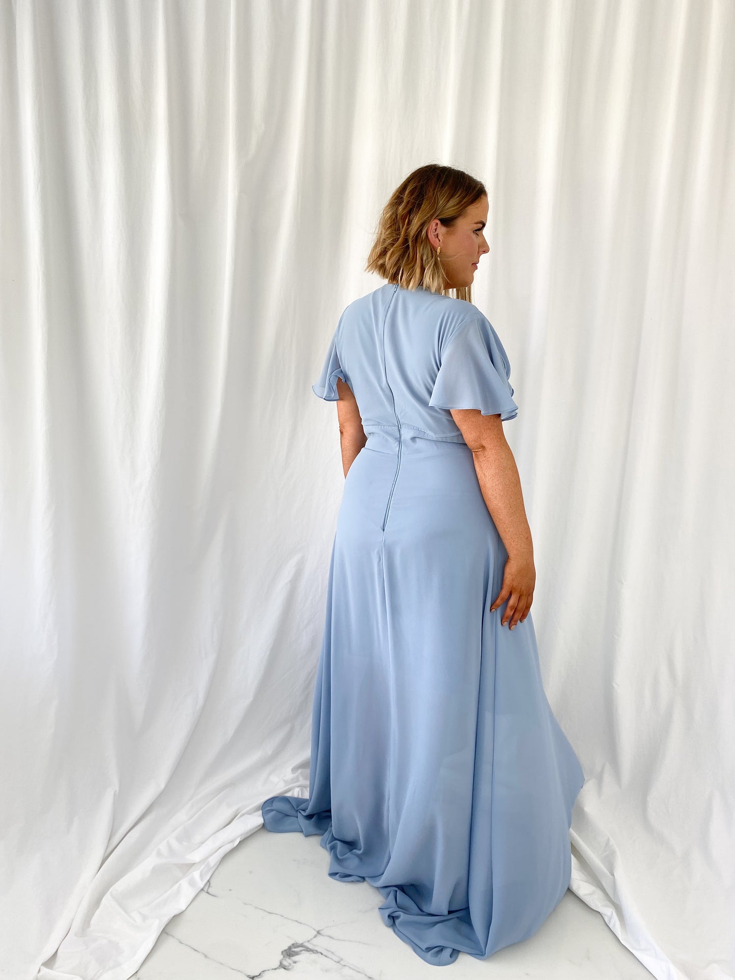 a man standing next to a woman in a white dress