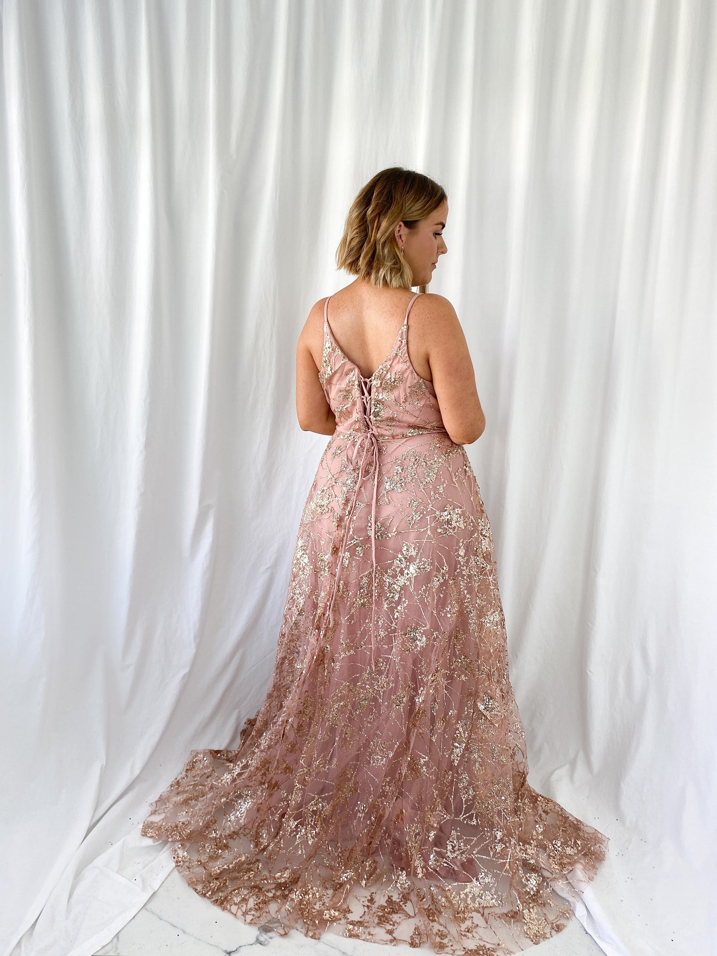 a woman in a white dress standing in a white dress