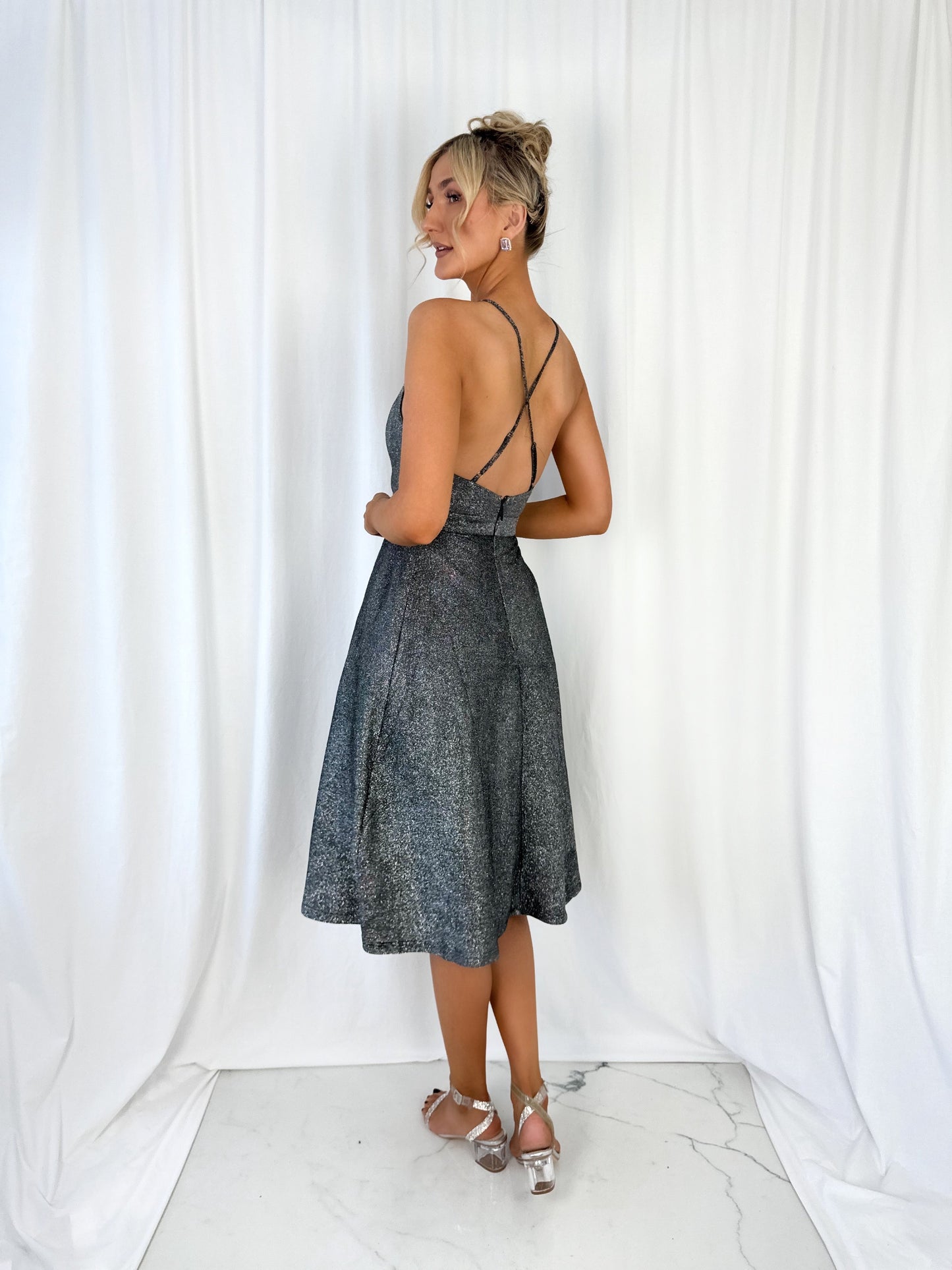 a woman in a dress talking on a cell phone