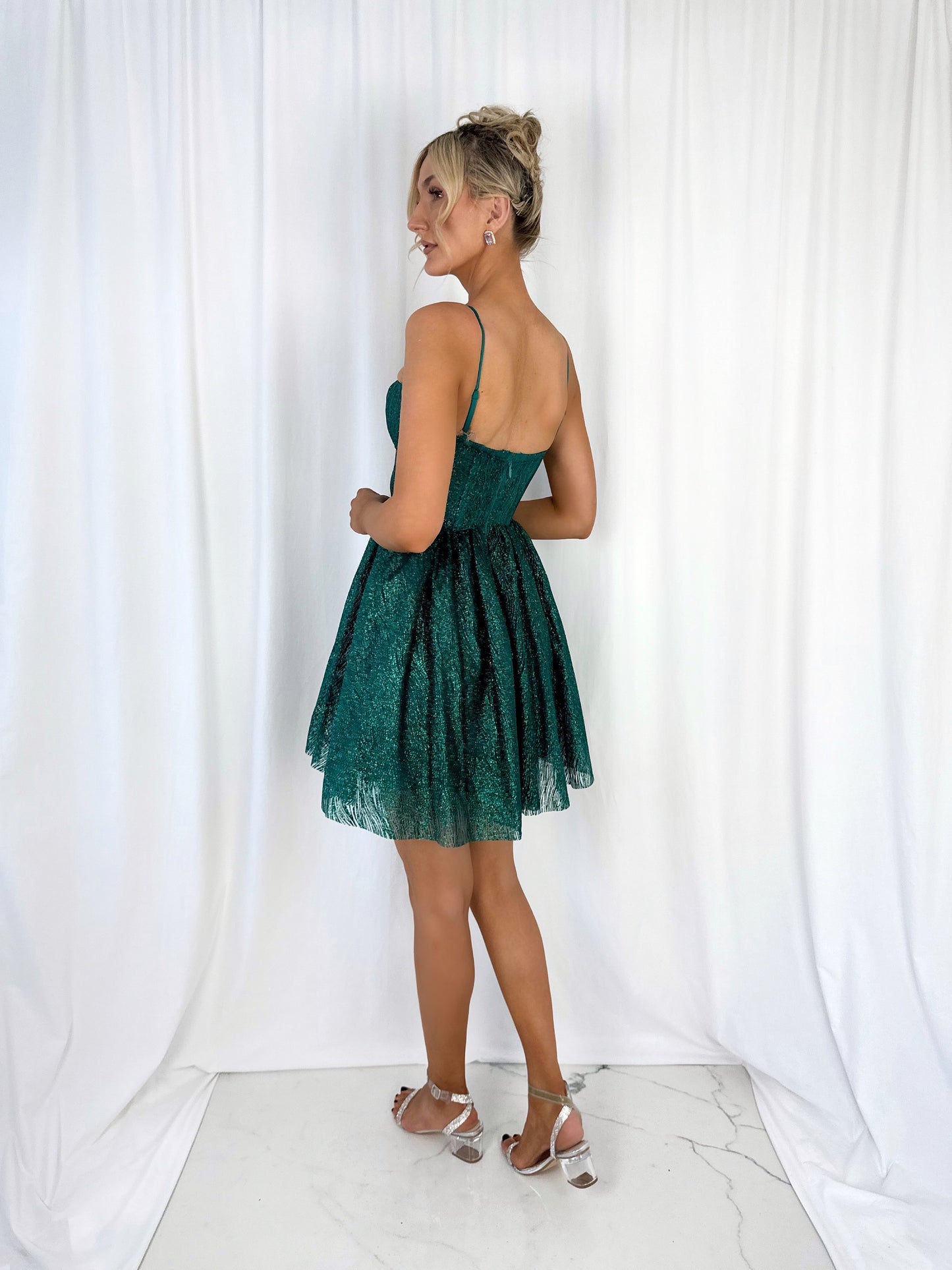 a woman in a dress standing on a couch