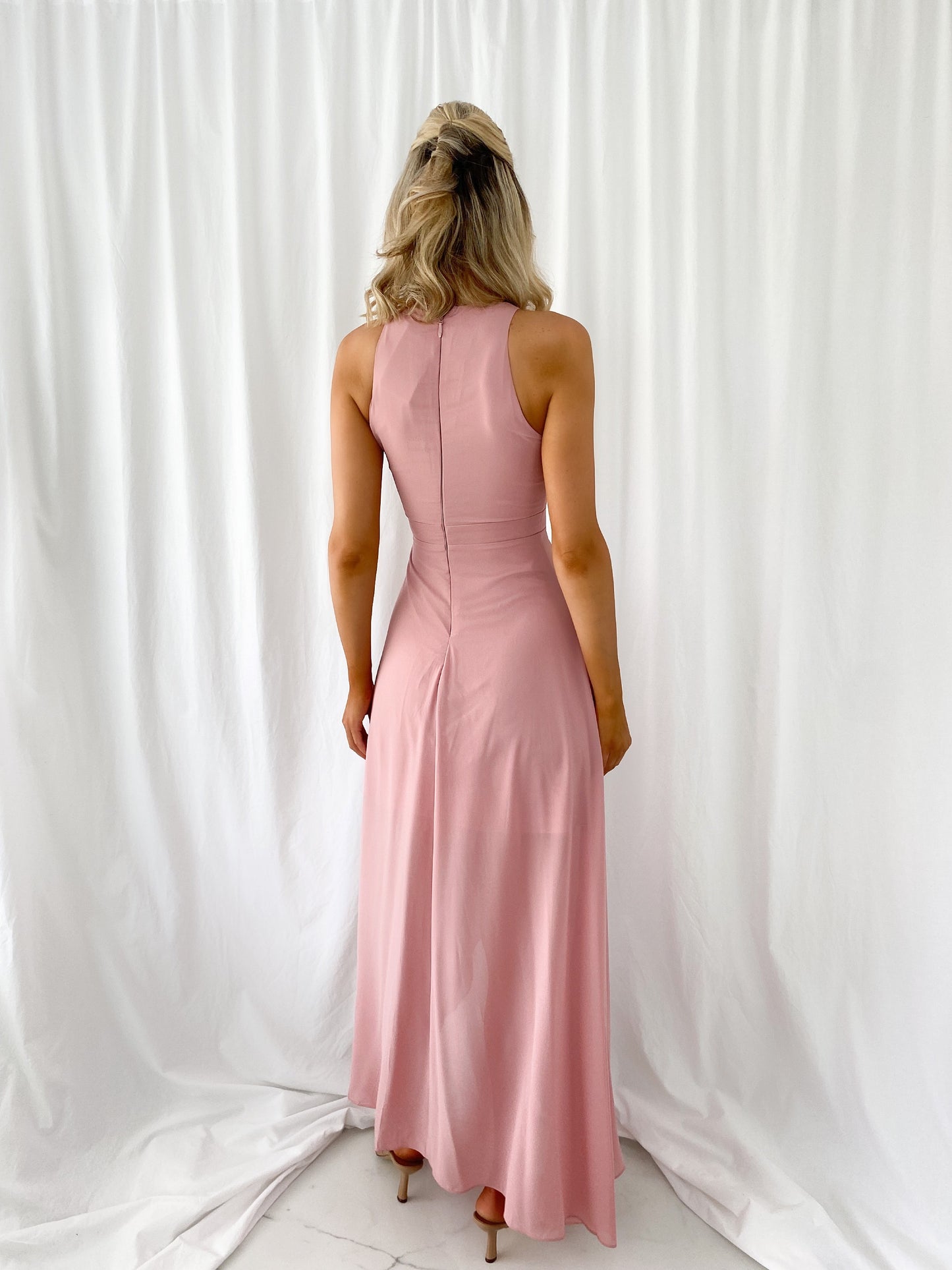 a woman in a pink dress in a white dress