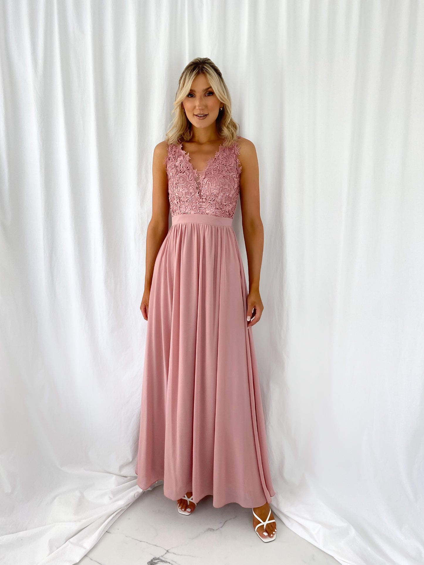 a woman in a pink dress in a white dress