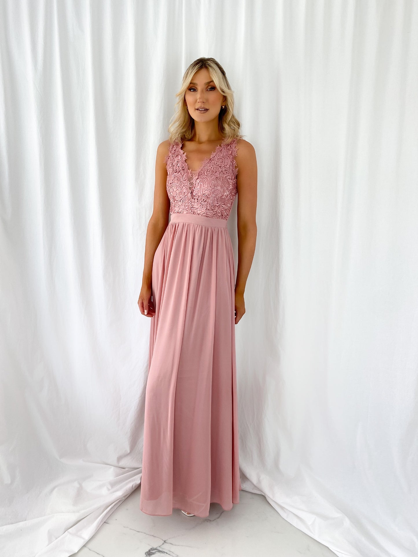 a woman in a pink dress in a white dress