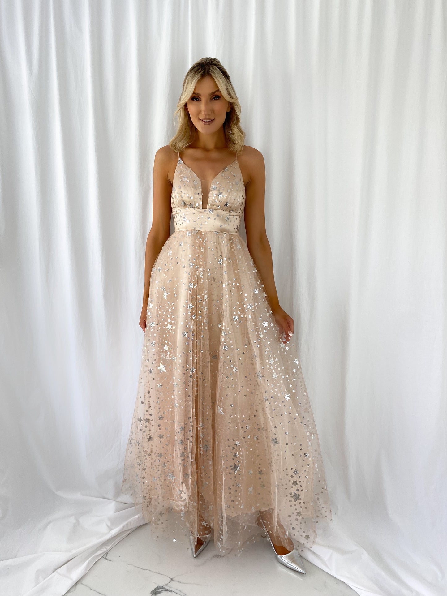 a woman in a white dress holding a purse