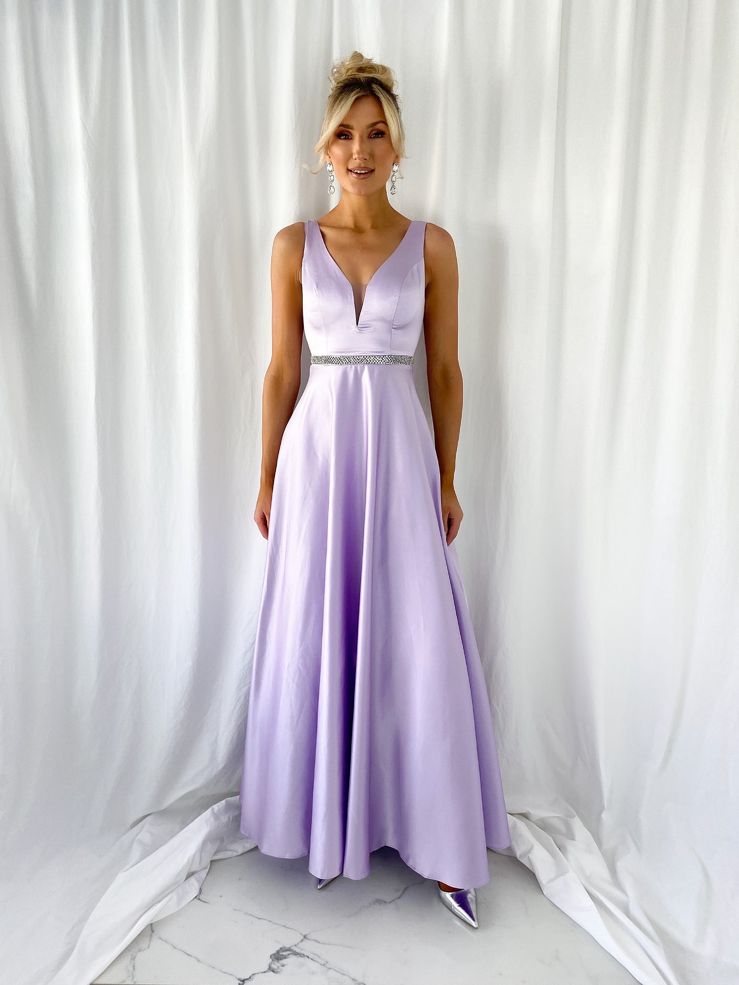 a woman in a pink dress standing in a white dress