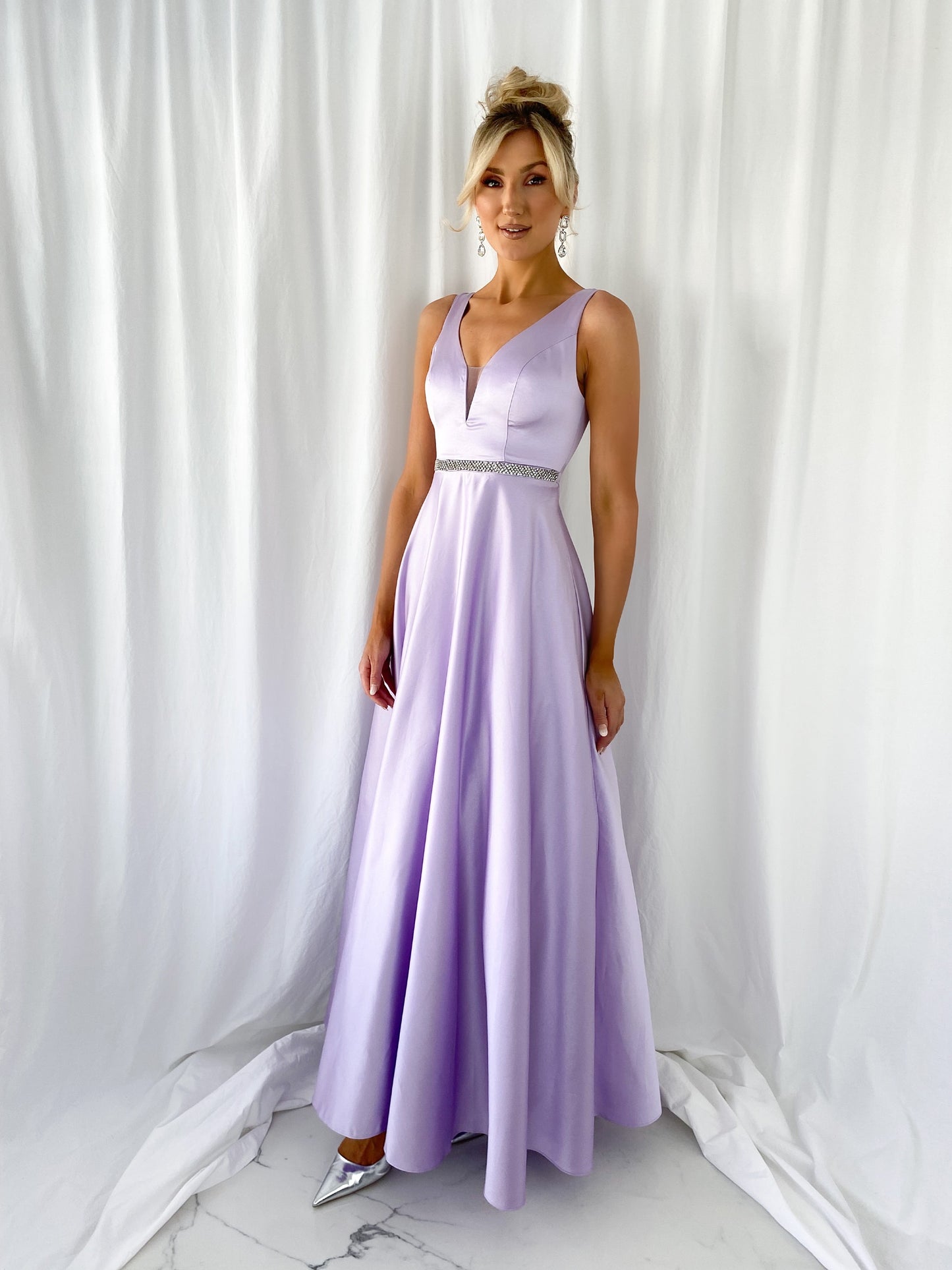 a woman in a pink dress standing in a white dress