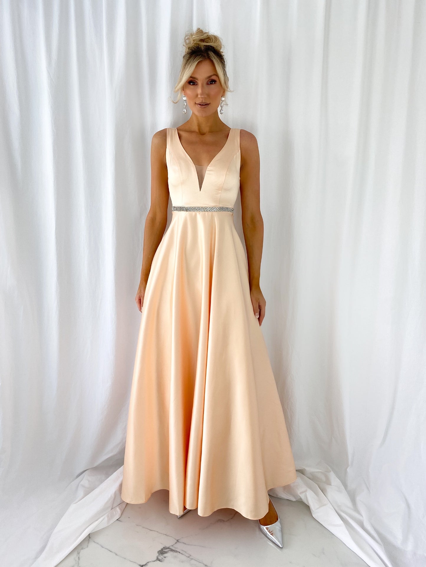a woman in a white dress standing in a white dress