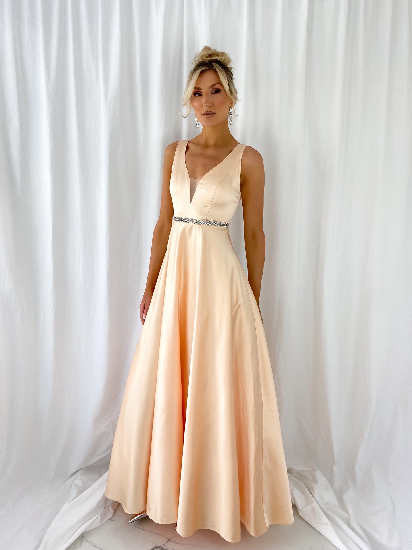 a woman in a white dress standing in a white dress