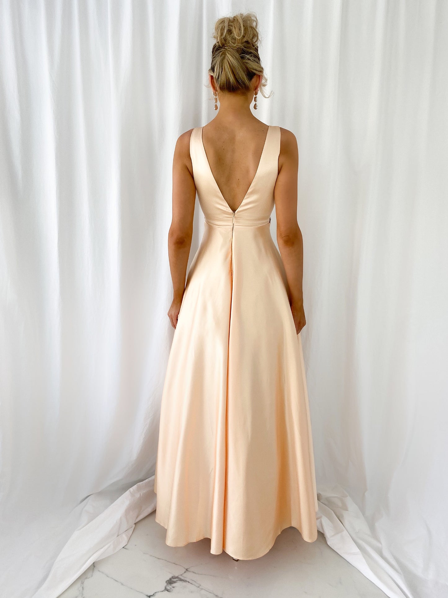 a woman in a white dress standing in a white dress