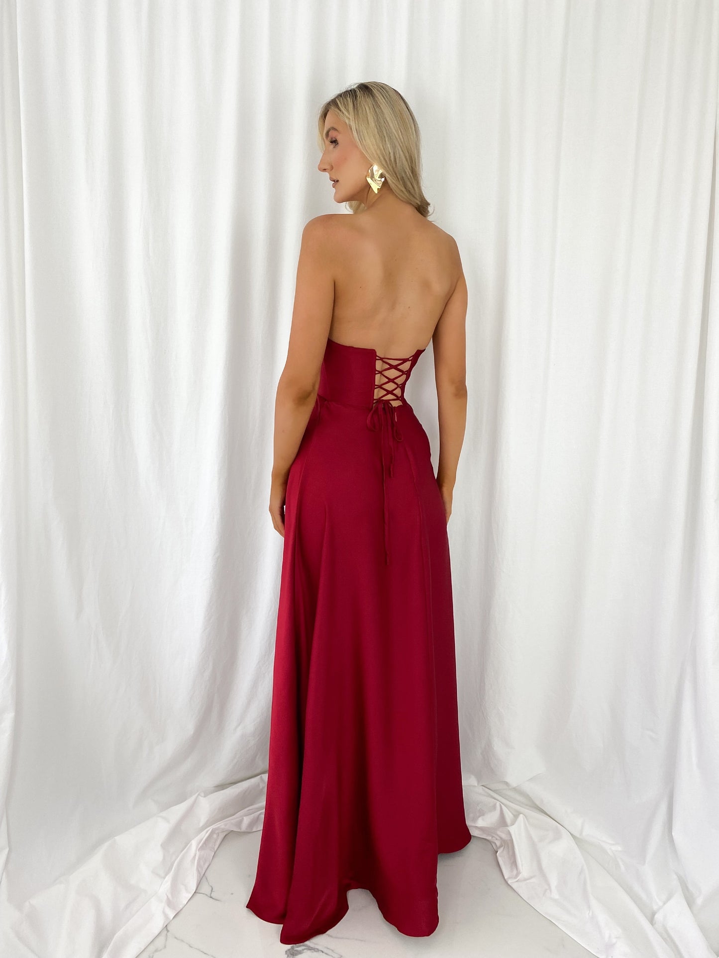 a woman in a red dress in a white dress