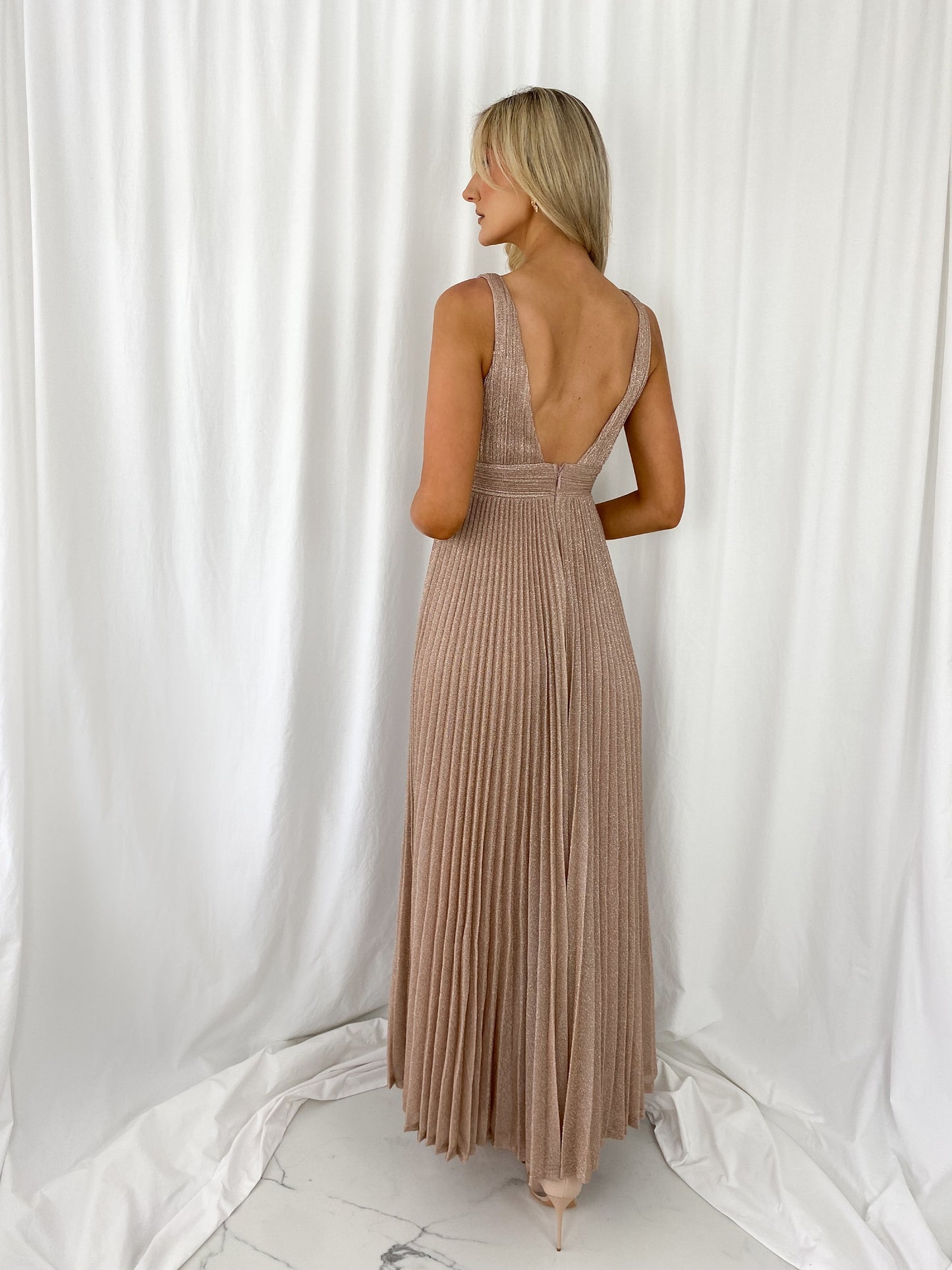 a woman in a white dress standing in a white dress