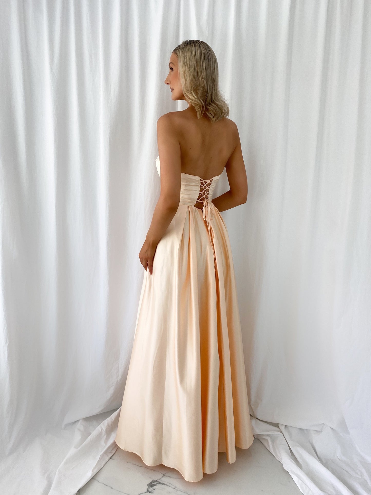 a woman in a white dress standing in a white dress