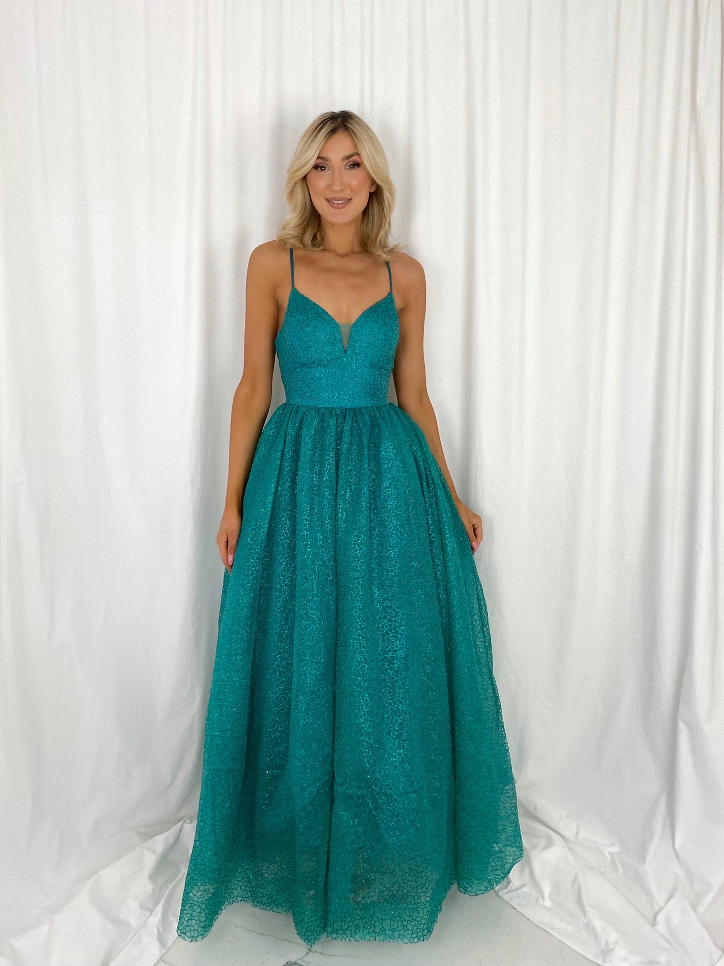 a woman in a green dress in a white dress