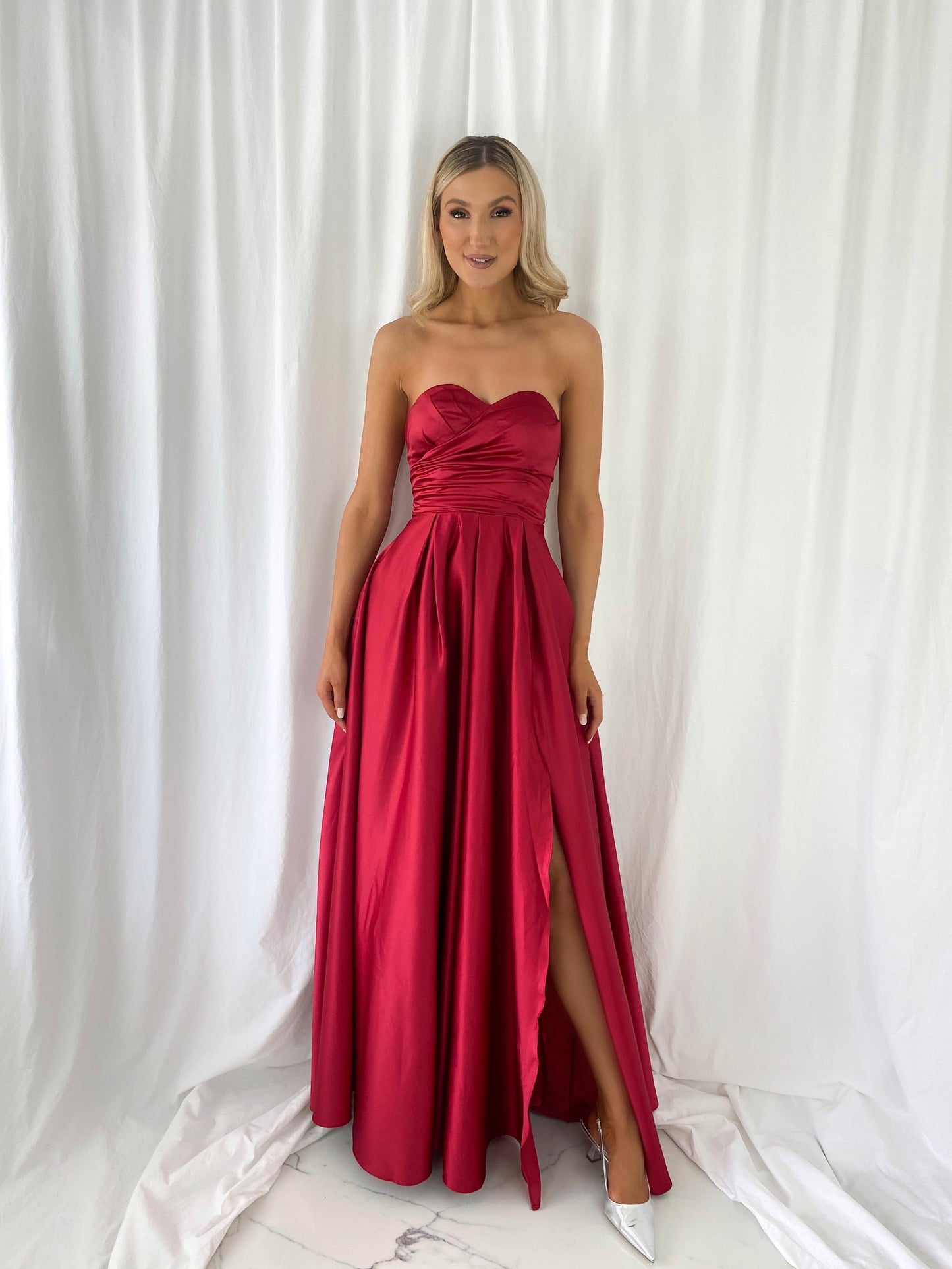 a woman in a red dress in a white dress