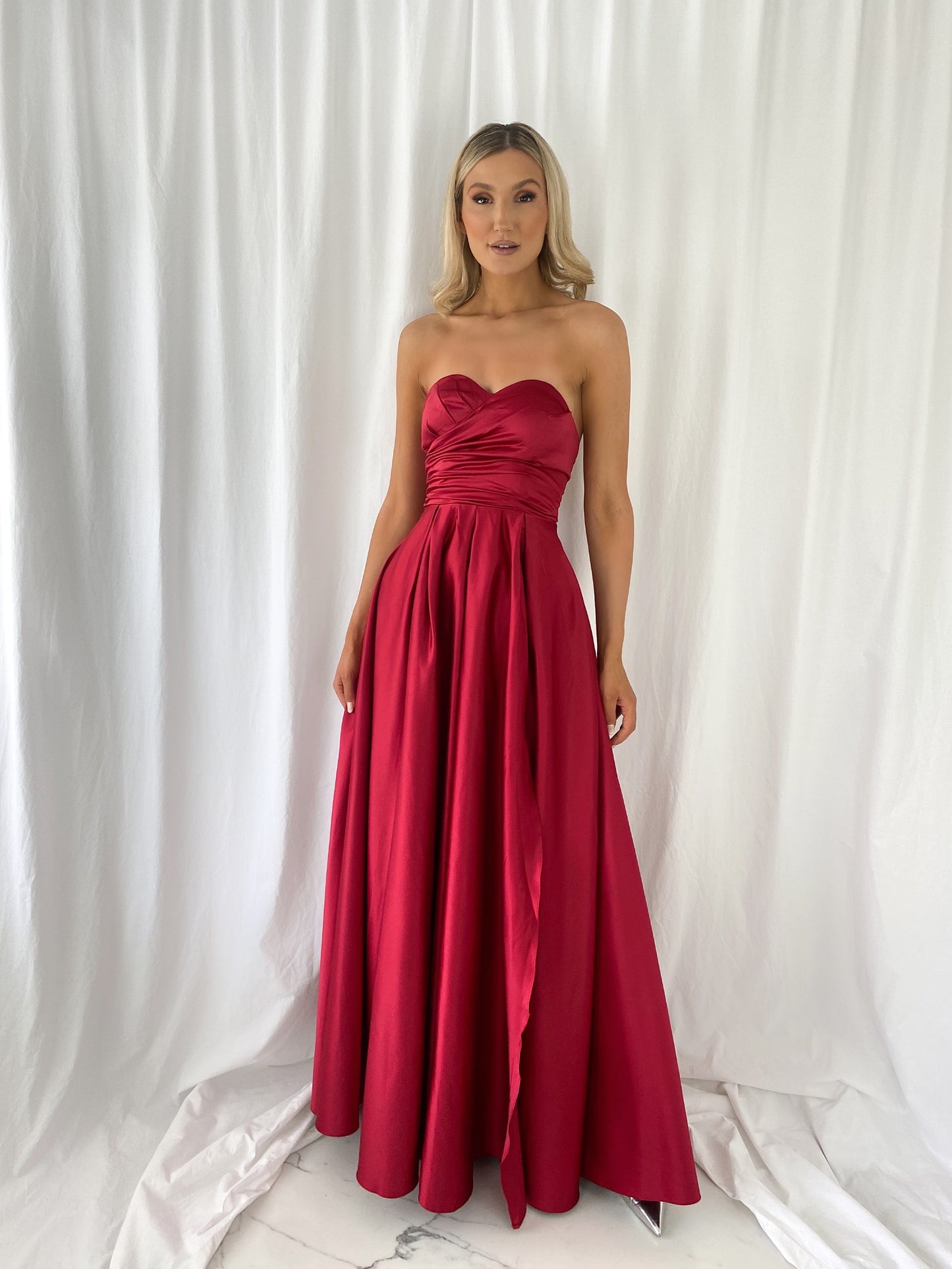 a woman in a red dress in a white dress