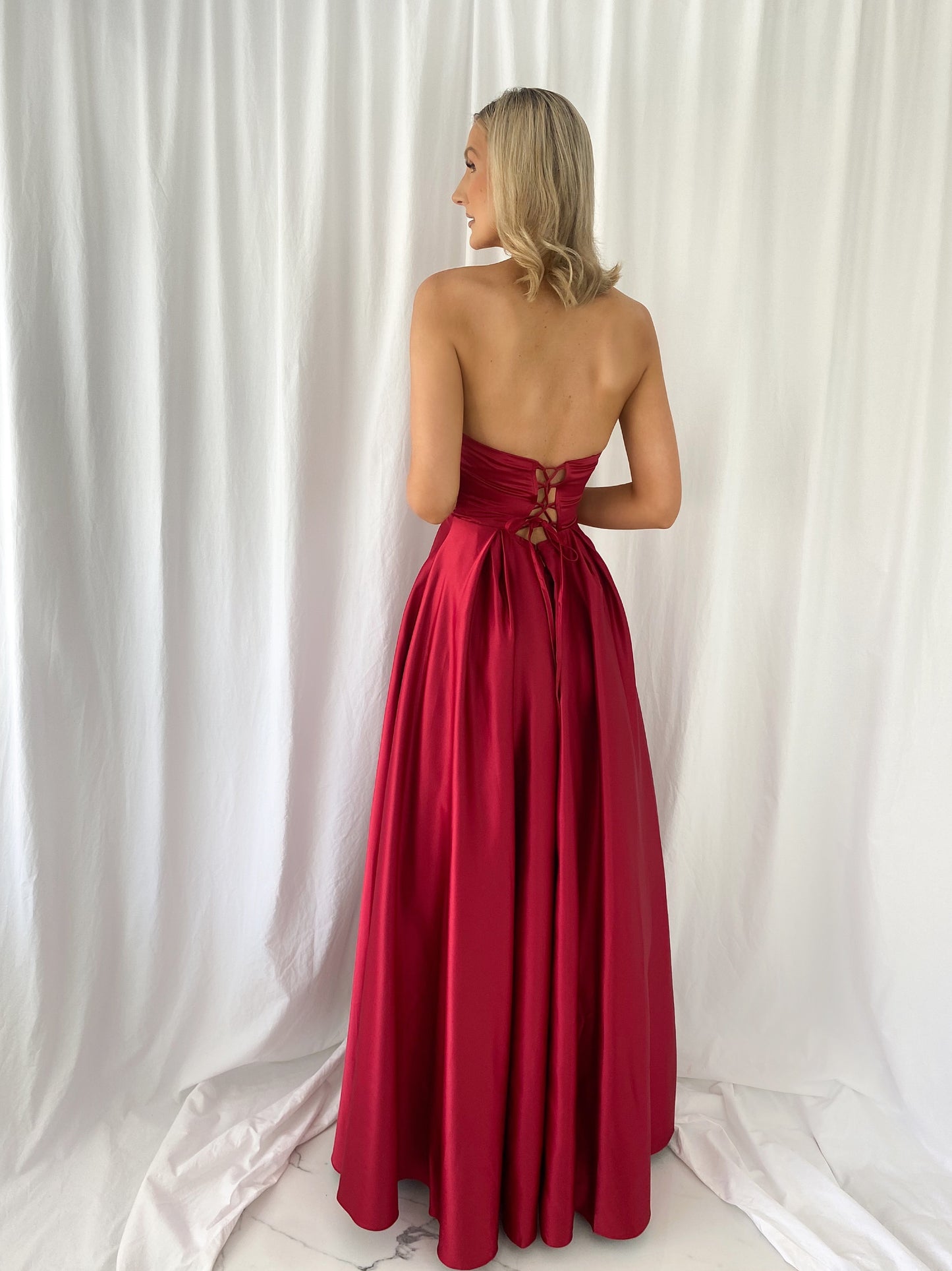 a woman in a red dress in a white dress