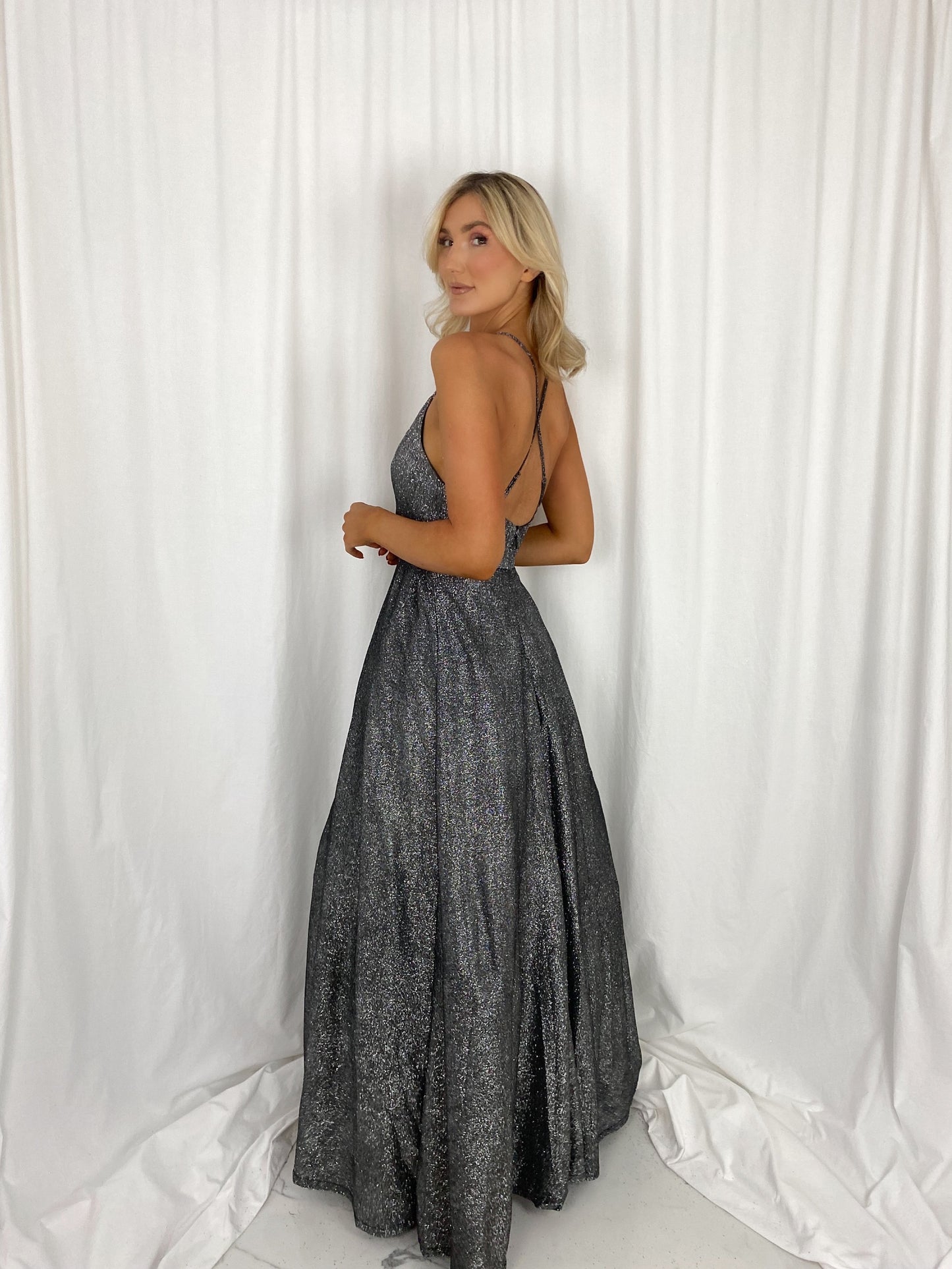 a woman in a dress is standing on a bed