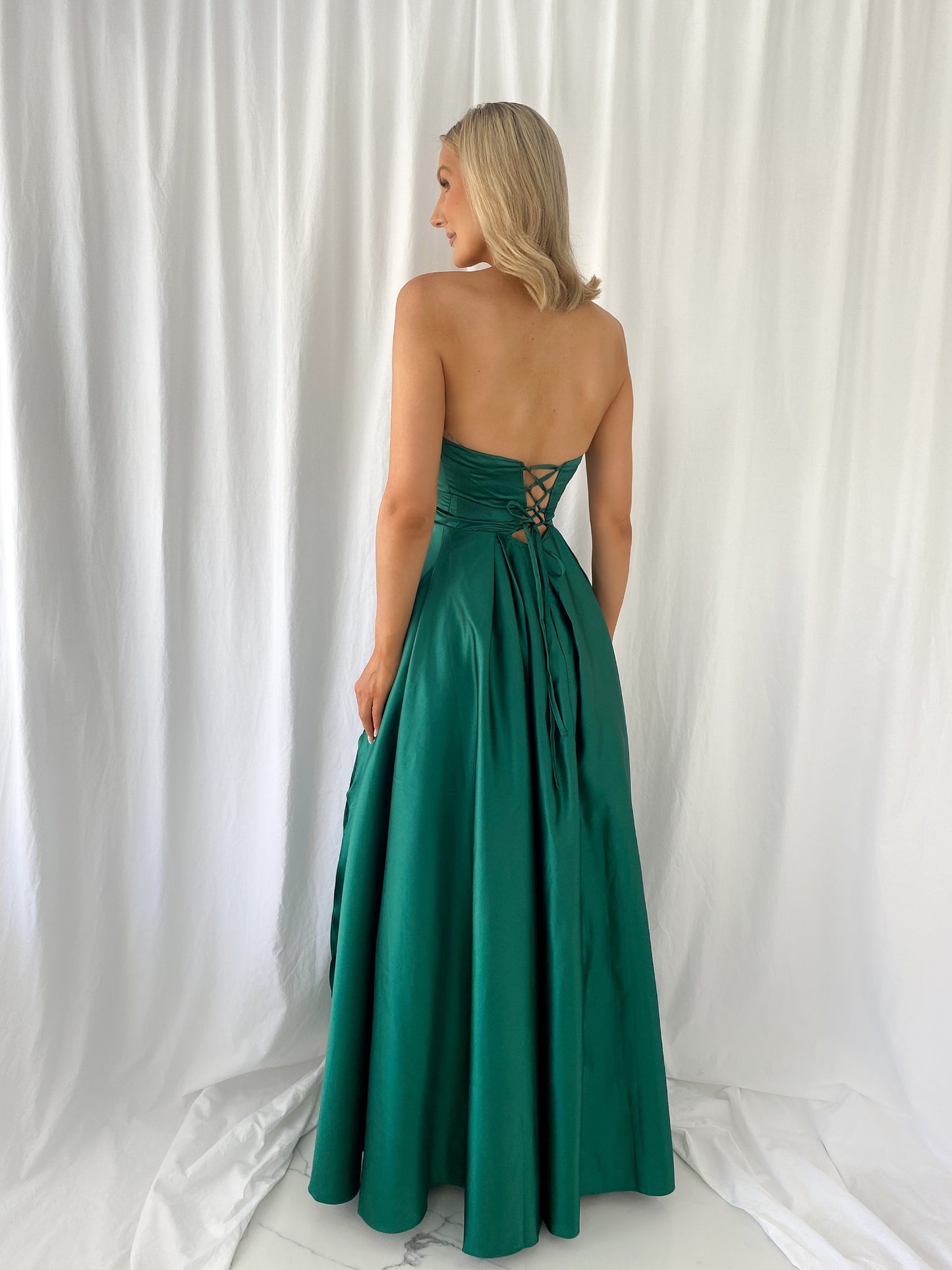 a woman in a green dress in a white dress