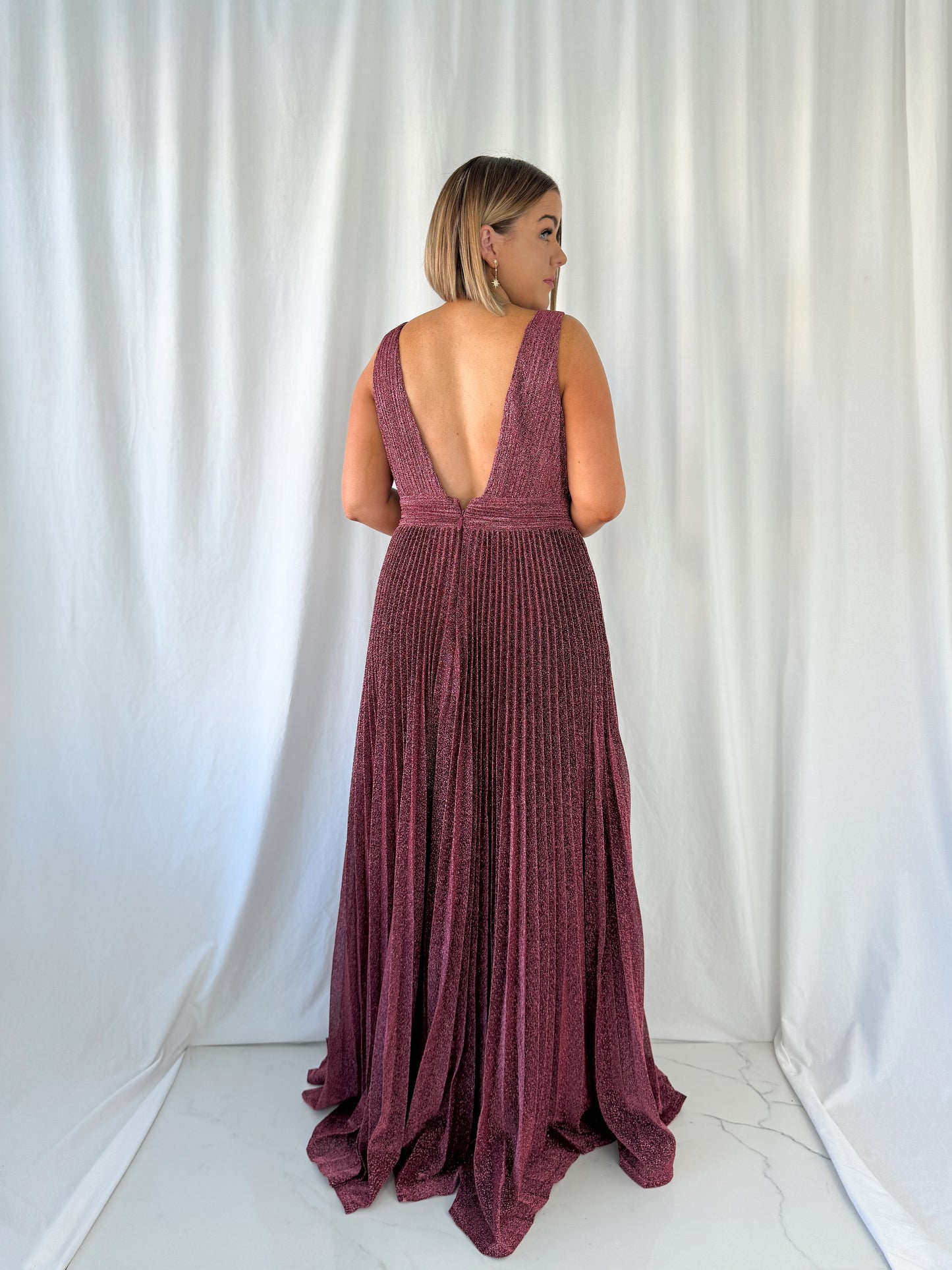 a woman in a white dress standing in a white dress