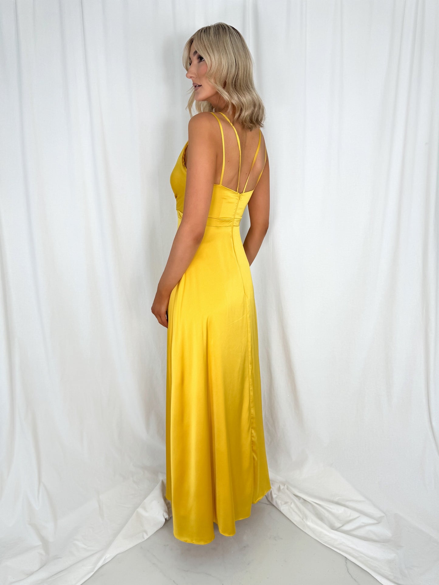 a woman in a yellow dress in a white dress