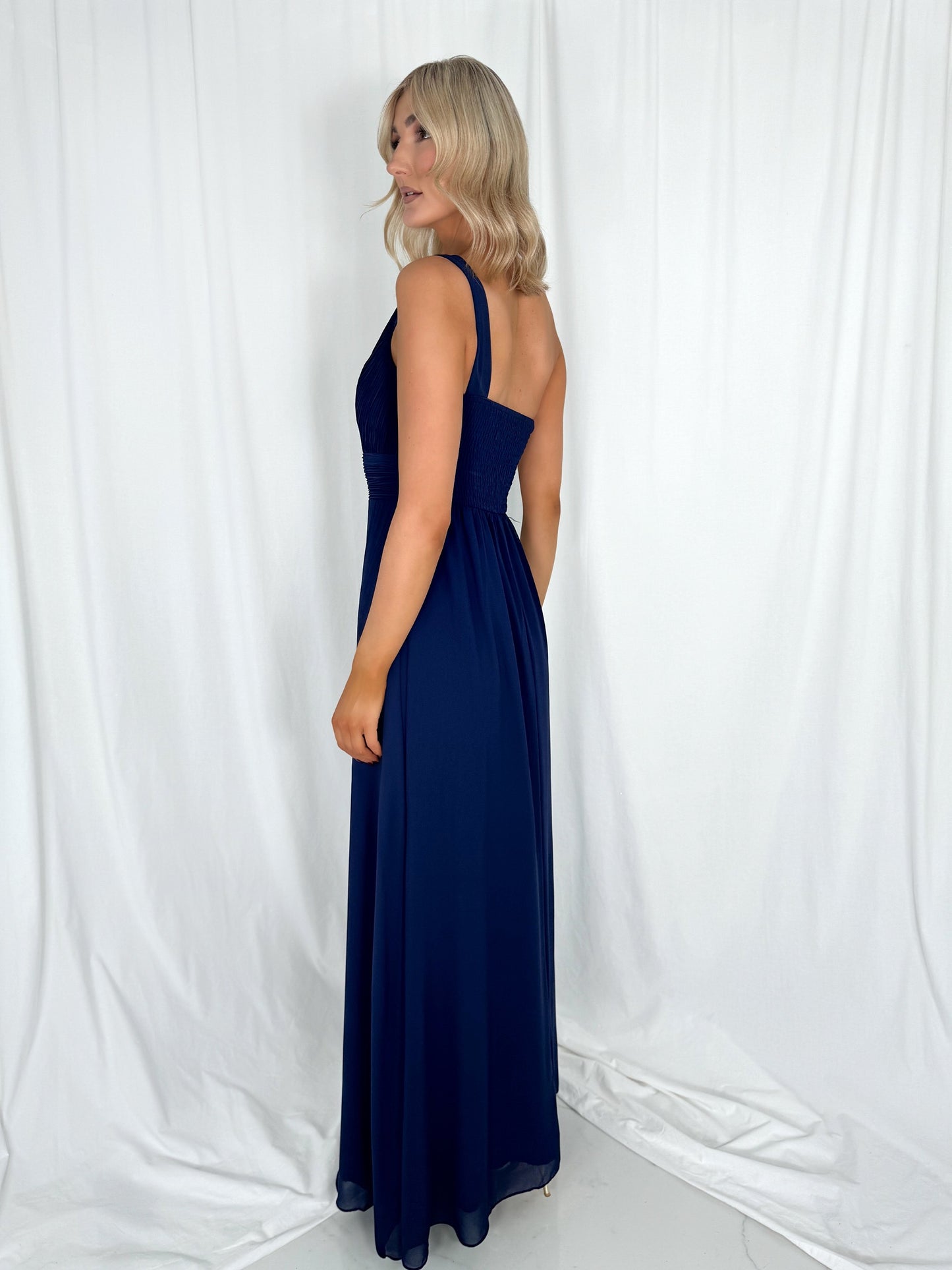 a woman in a dress talking on a cell phone