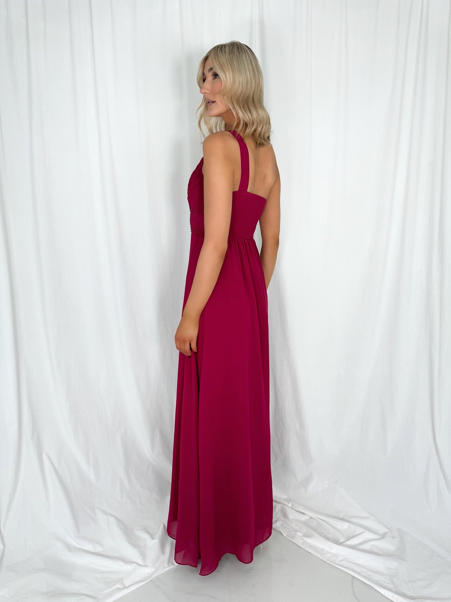 a woman in a pink dress in a white dress