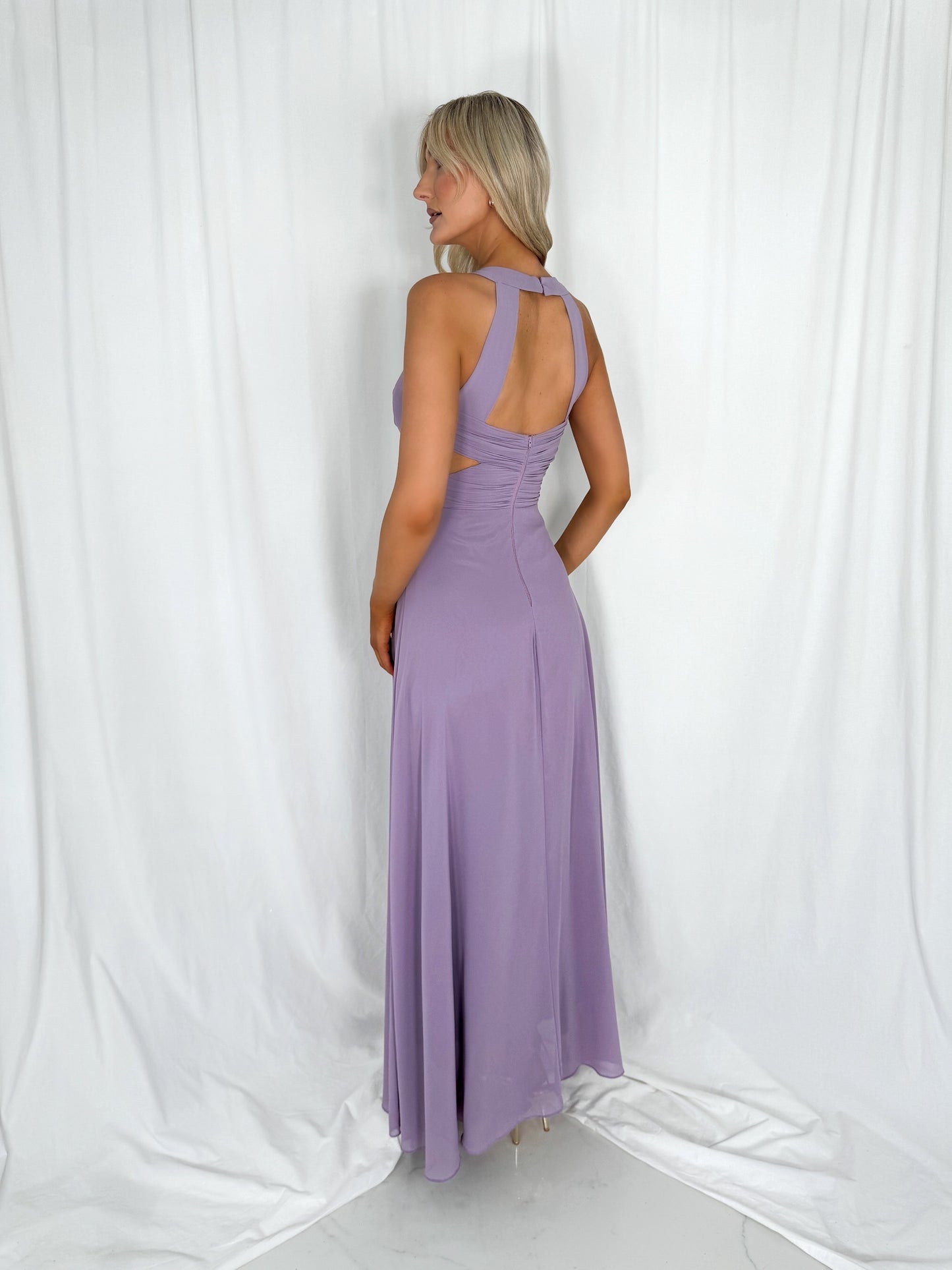 a woman in a pink dress standing next to a man