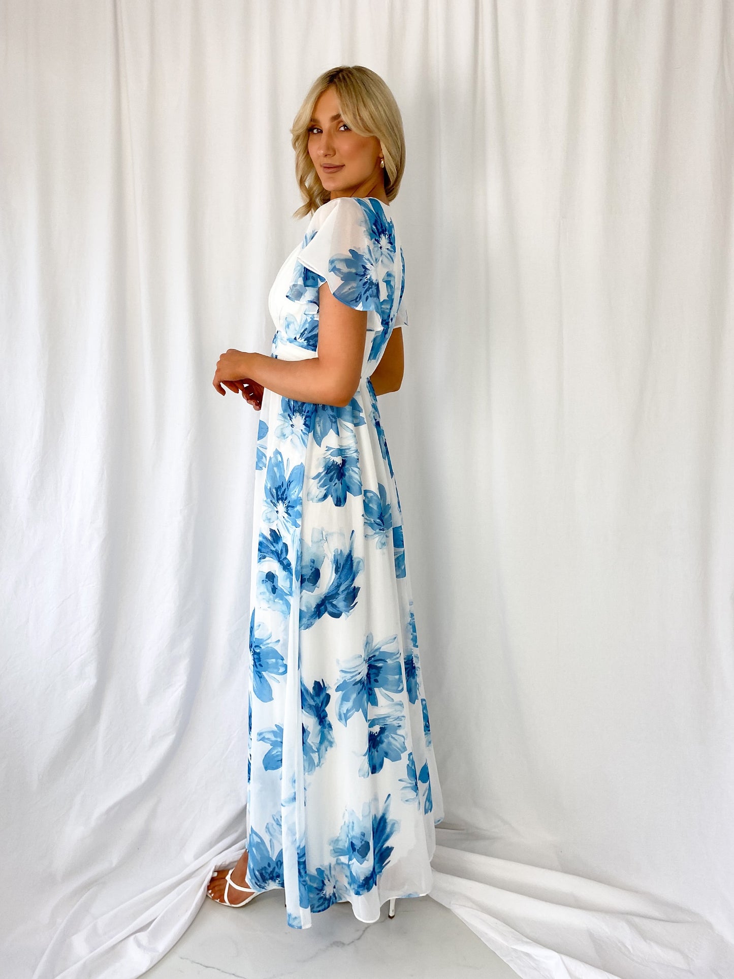 a little girl standing in front of a shower curtain