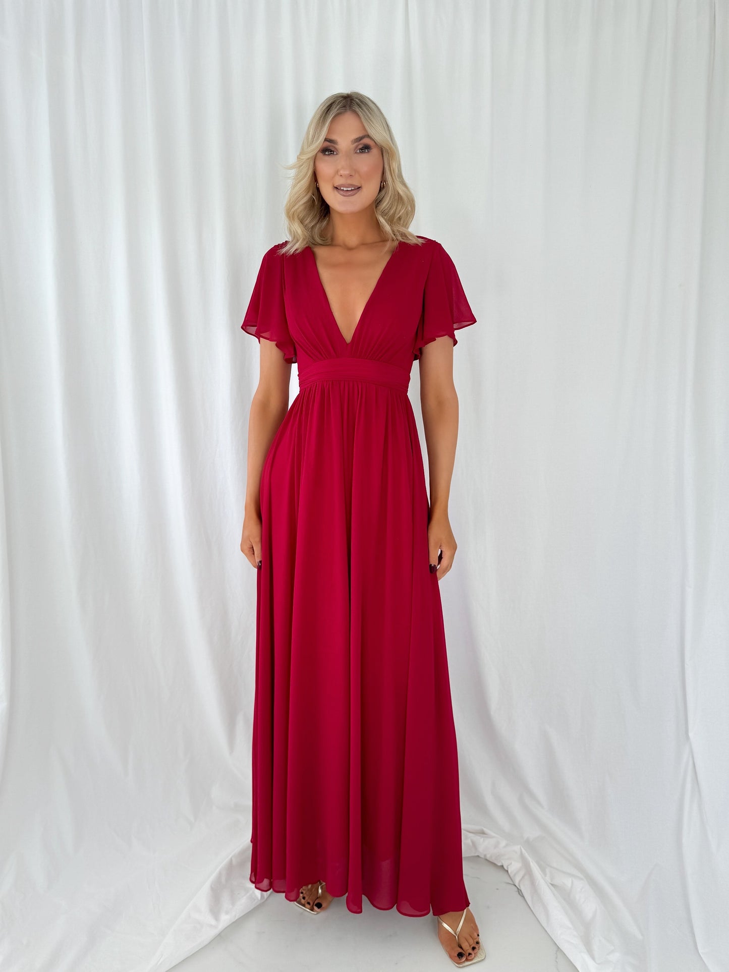 a woman in a red dress in a white dress