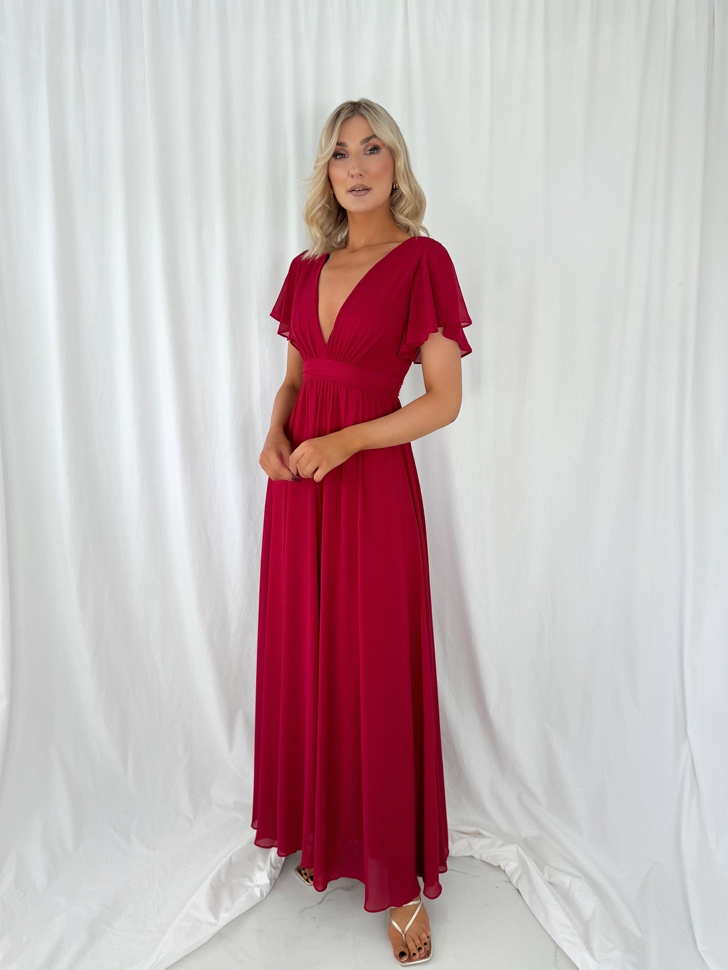 a woman in a red dress in a white dress