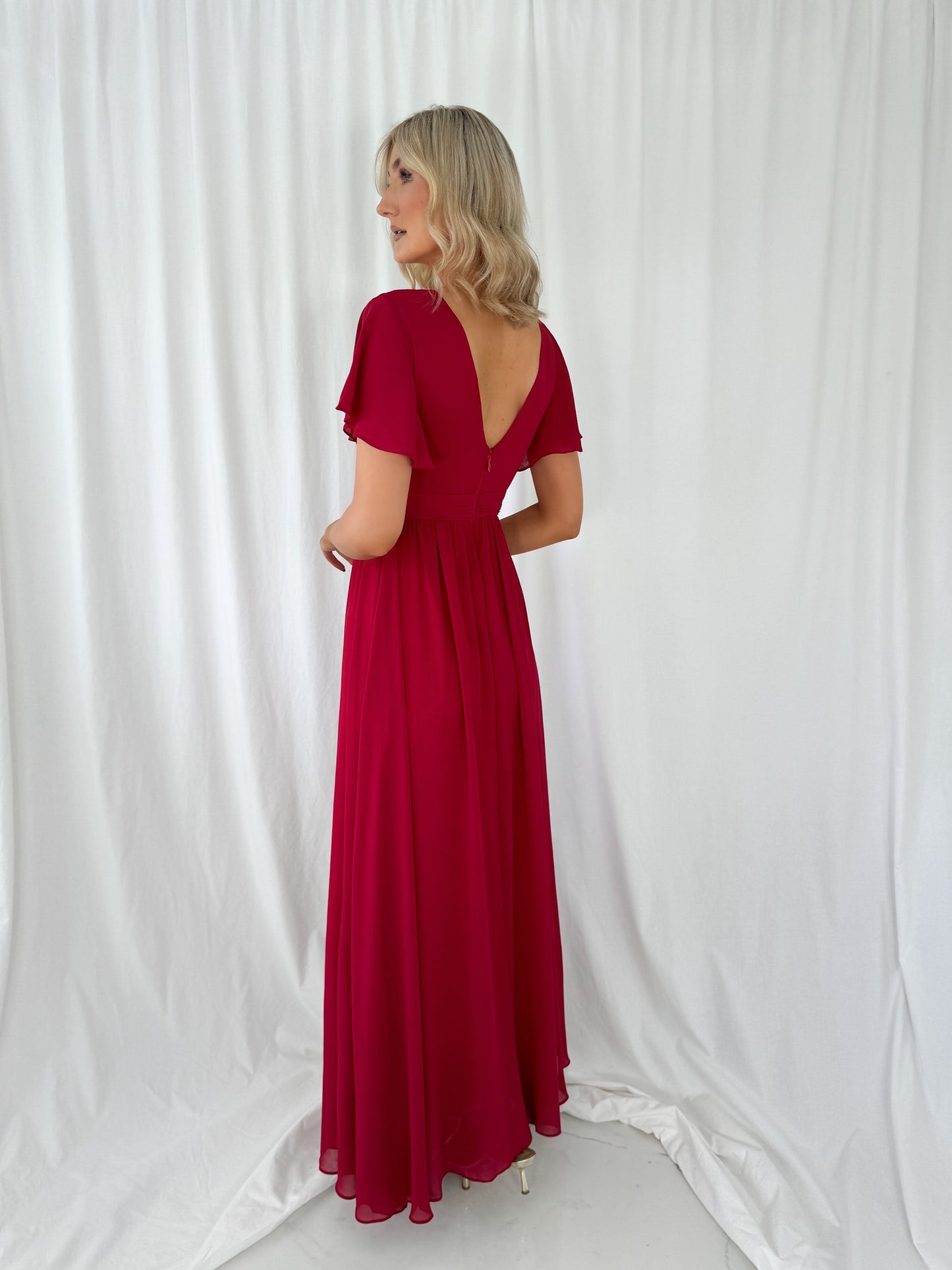 a woman in a red dress in a white dress