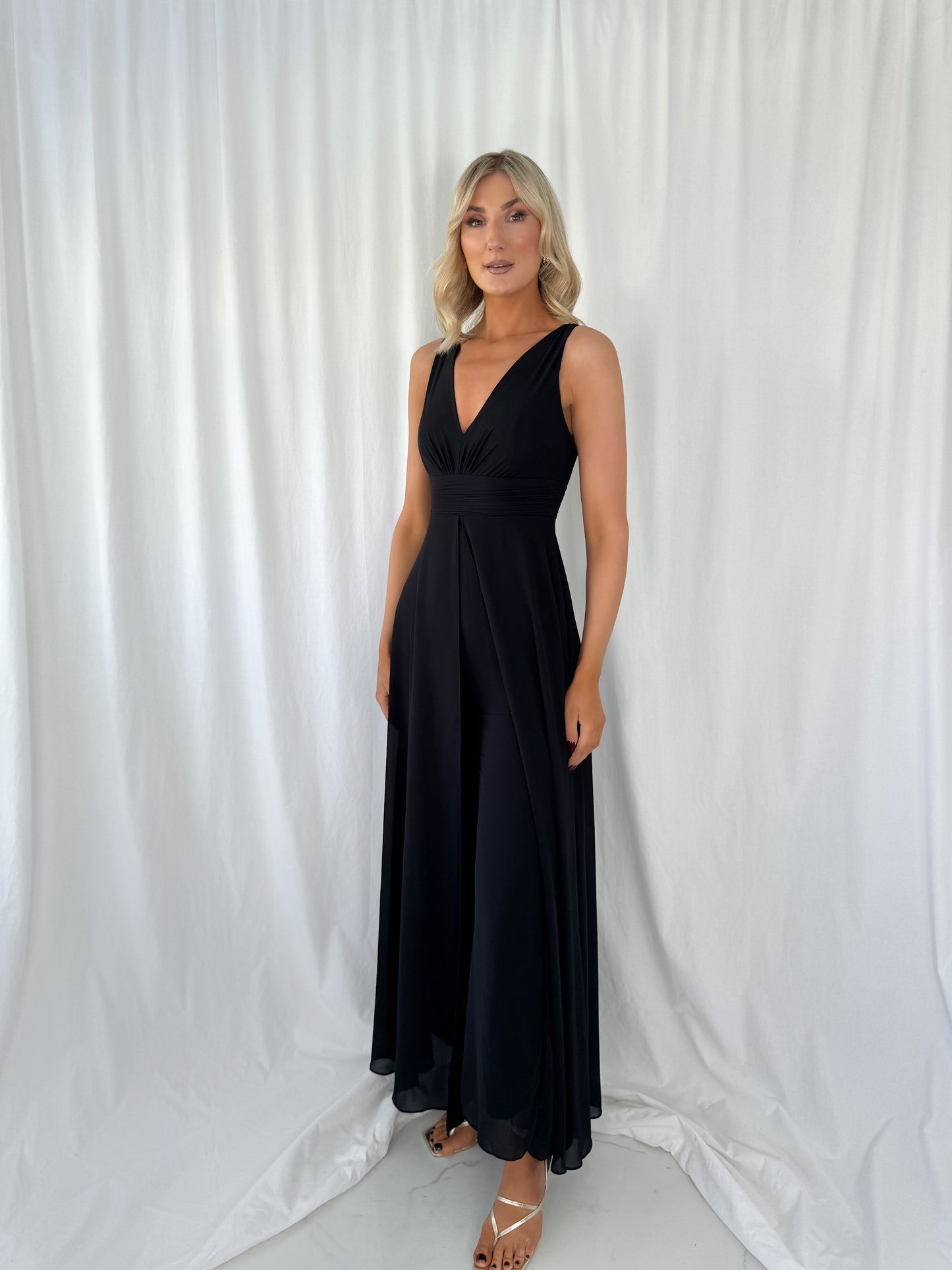 a woman in a dress talking on a cell phone