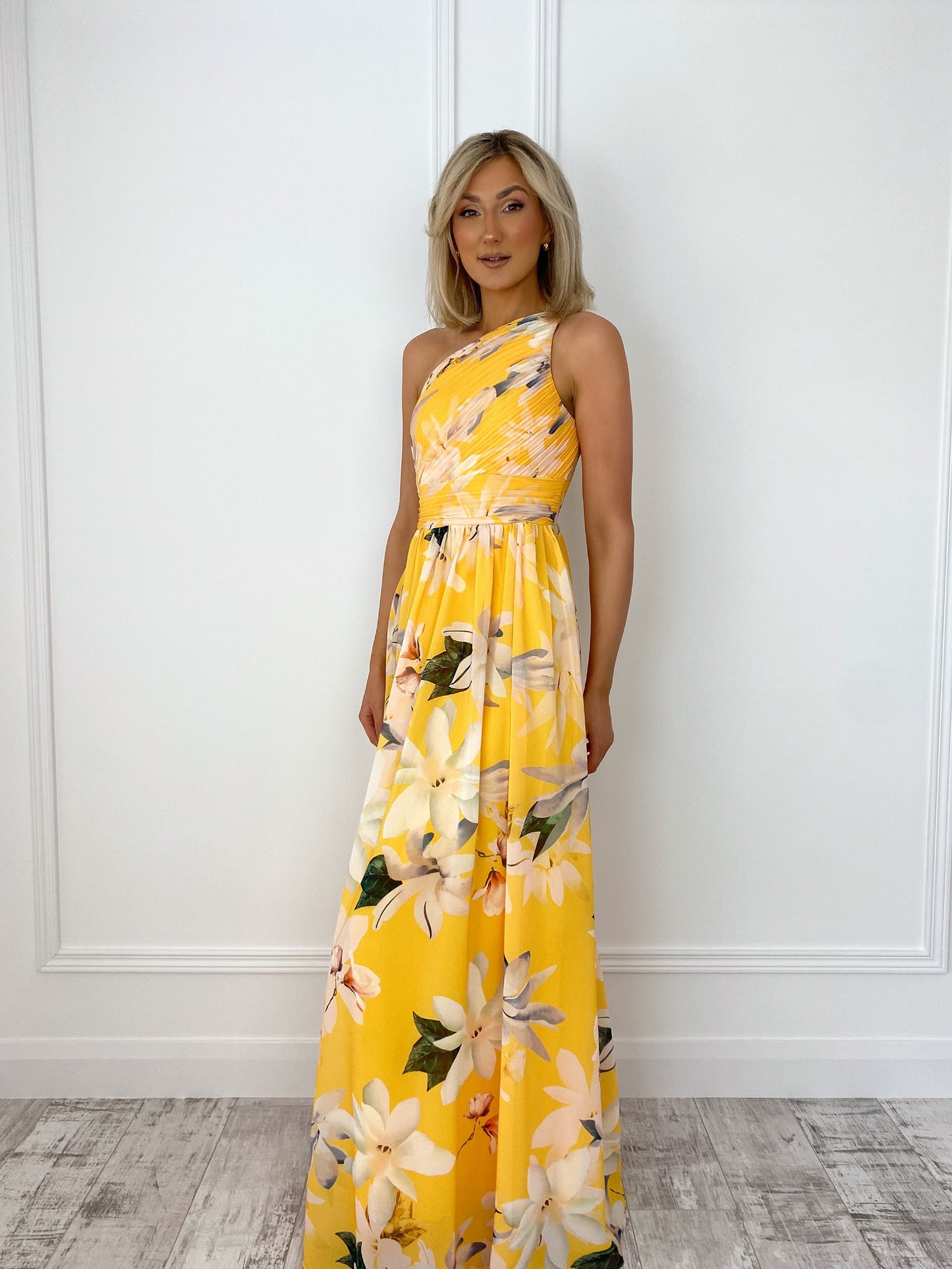 a woman in a yellow dress standing in front of a door 